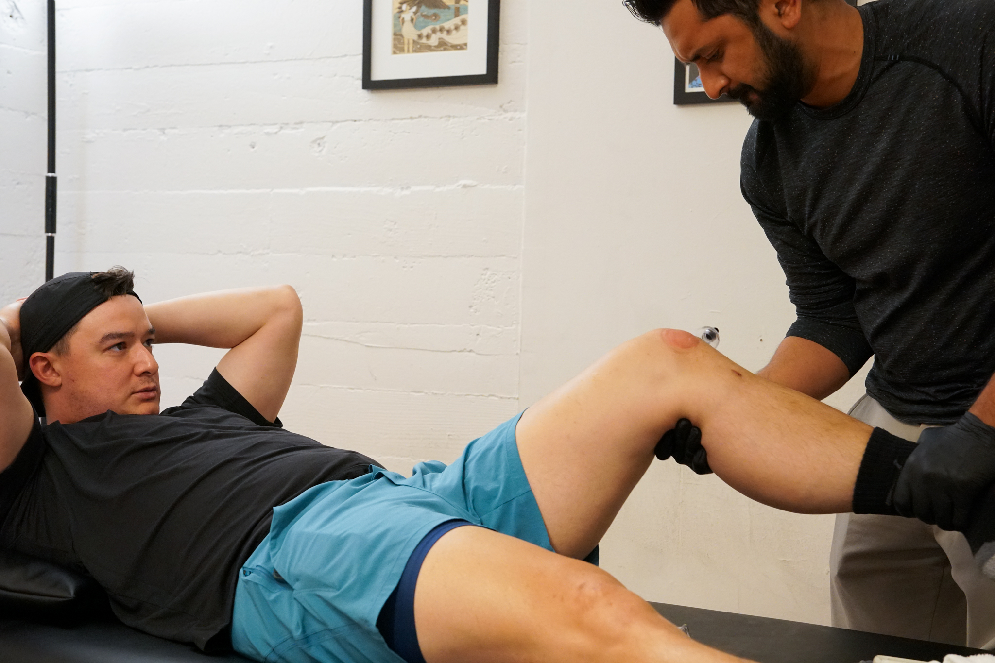 Athlete working with a provider on therapeutic exercise at a sports physical therapy clinic in Oakland, CA