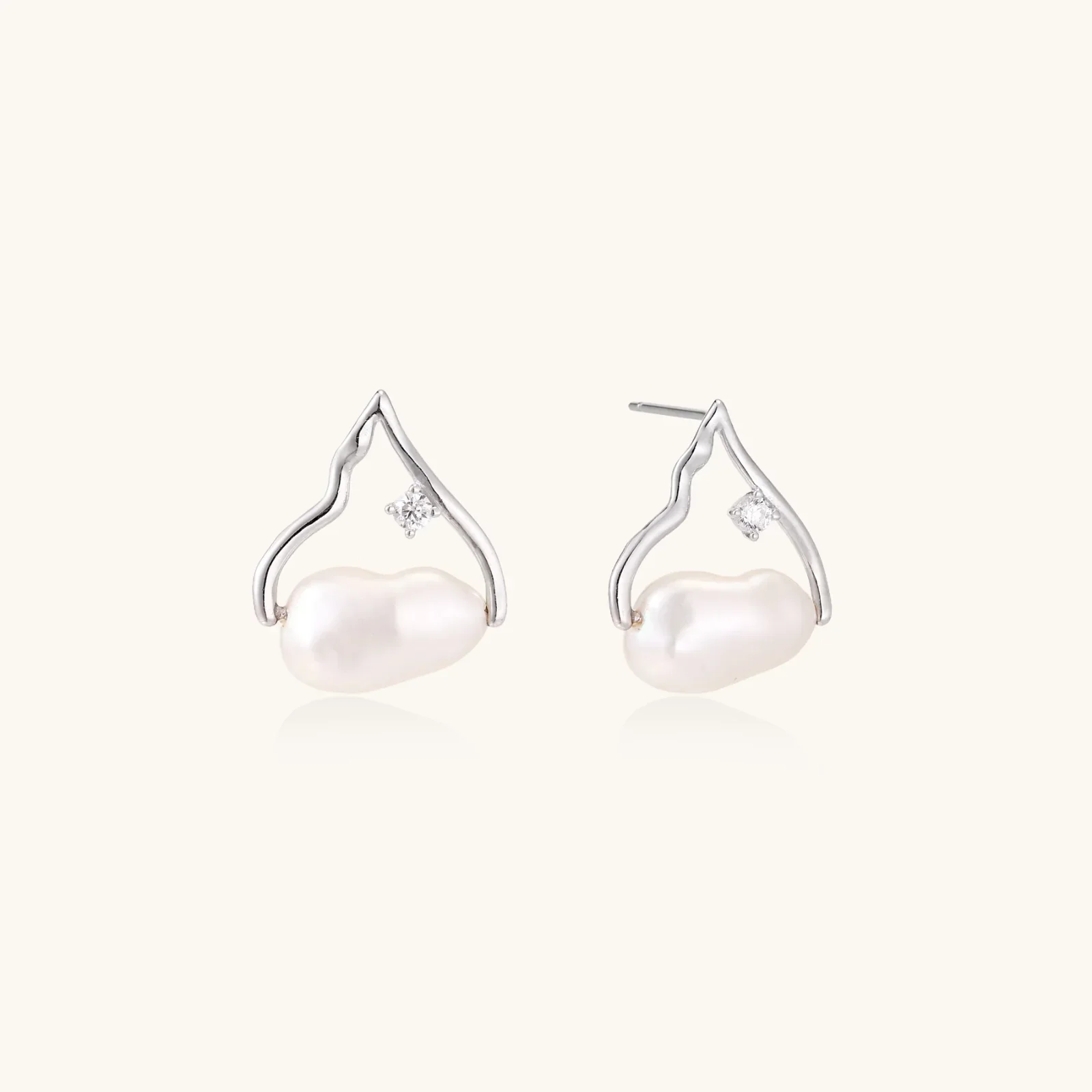 Silver mountain outline studs with baroque pearl and diamond accent on white background