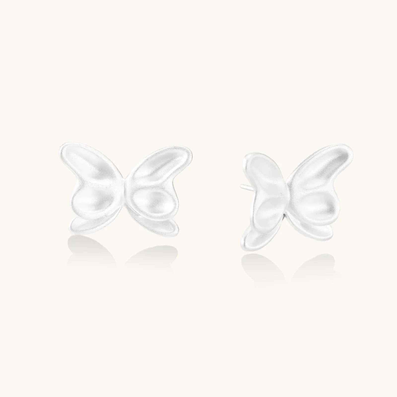 Pair of translucent butterfly-shaped stud earrings with frosted finish and dimensional wing details on white background