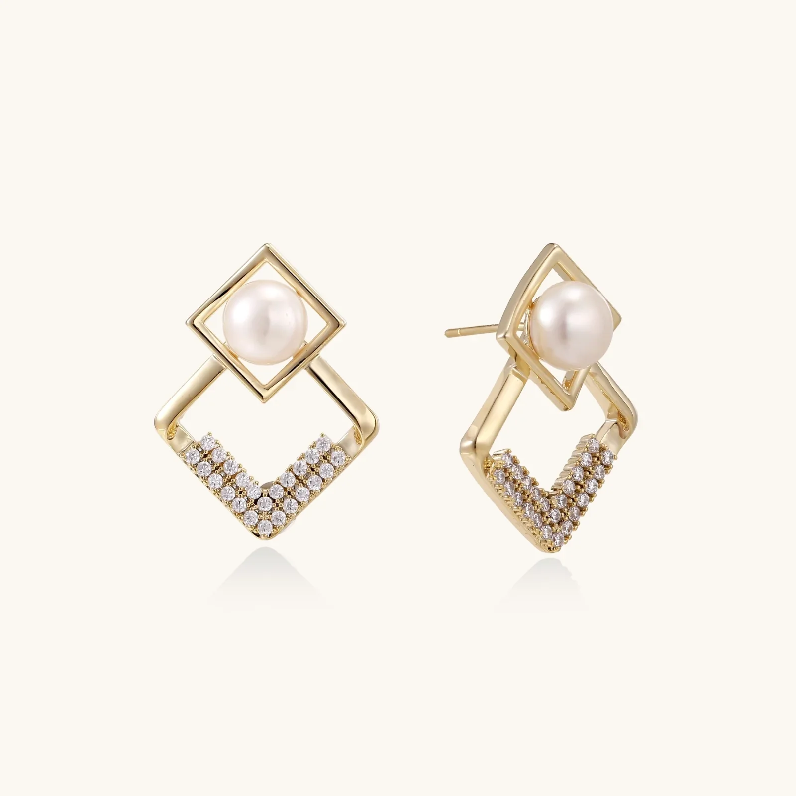 Gold-plated double square frame earrings with freshwater pearl and crystal accents on white background