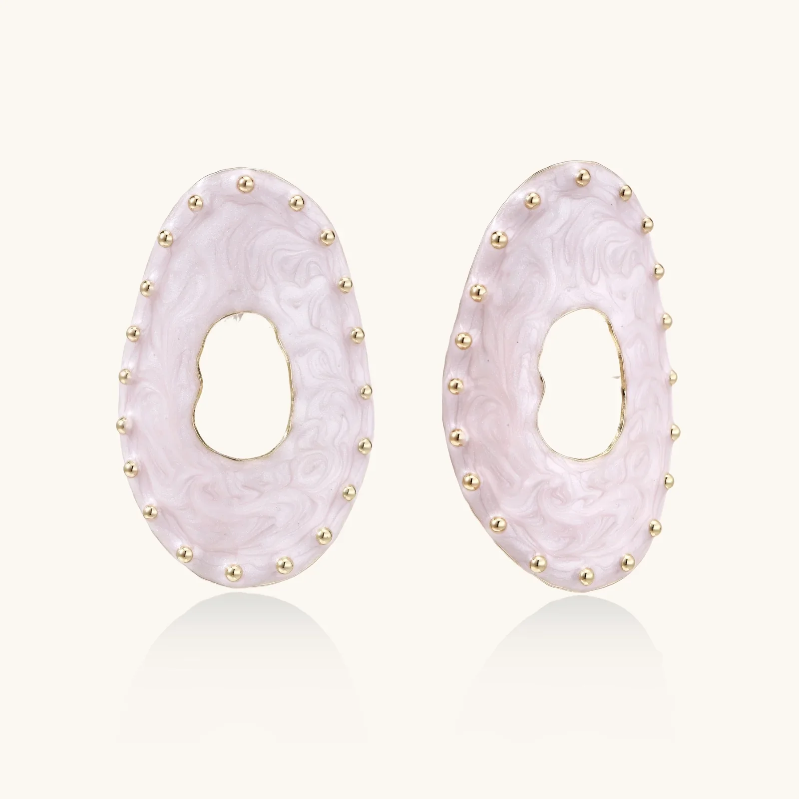 Oval lavender enamel earrings with marbled finish and gold-plated beaded border on cream background.