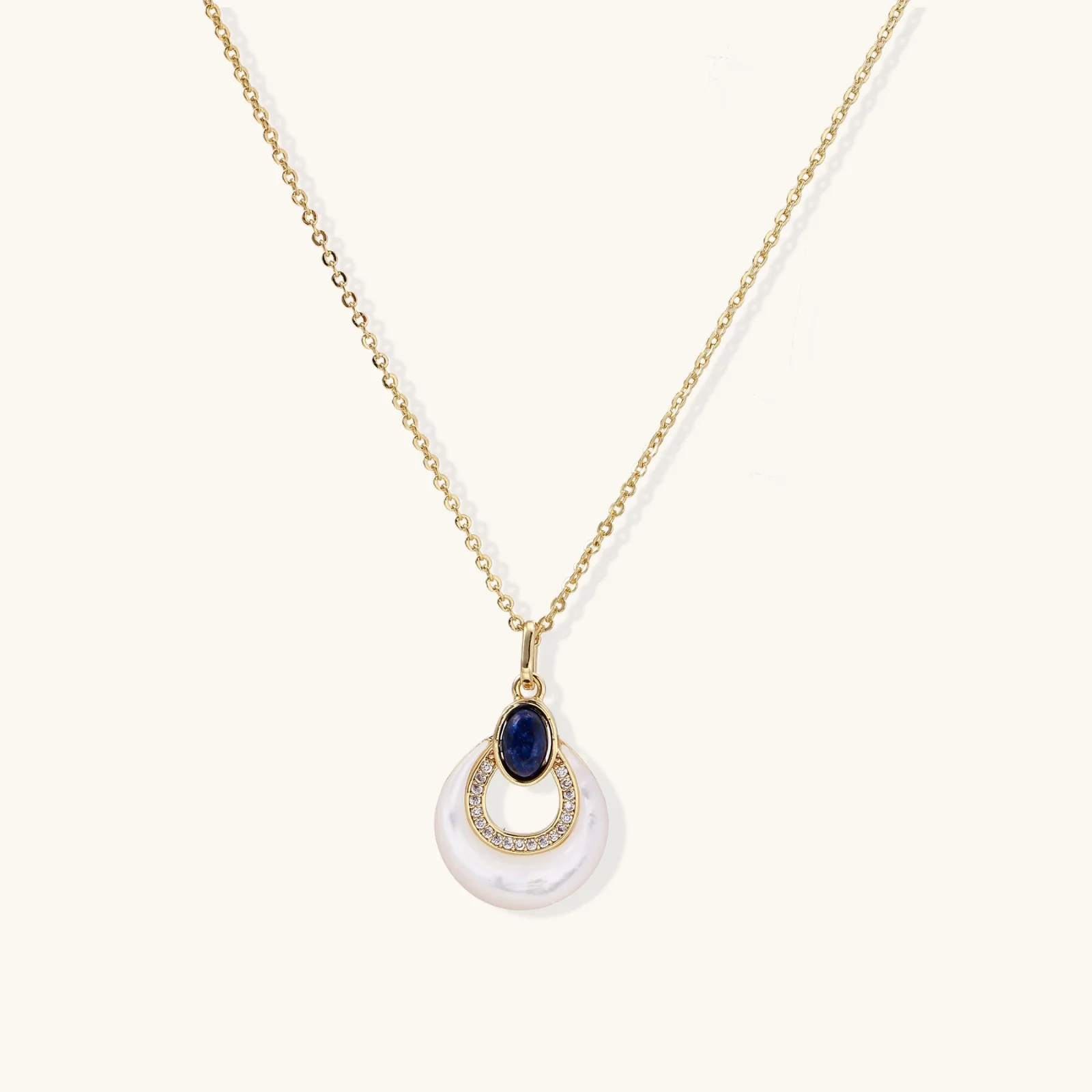 Gold necklace with navy lapis lazuli stone and iridescent mother-of-pearl teardrop pendant with crystal accents