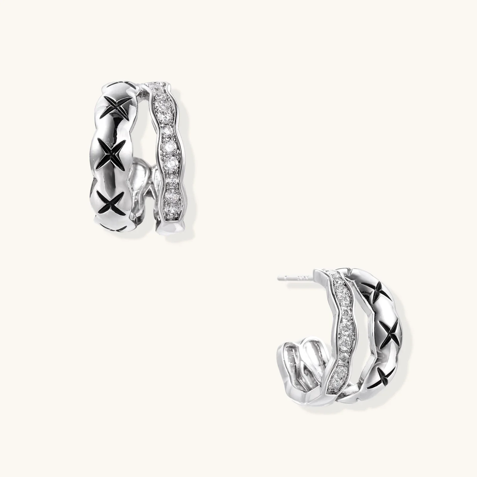 Triple-row white gold hoops with black X-pattern, twisted band, and pavé zirconia stones on white background.