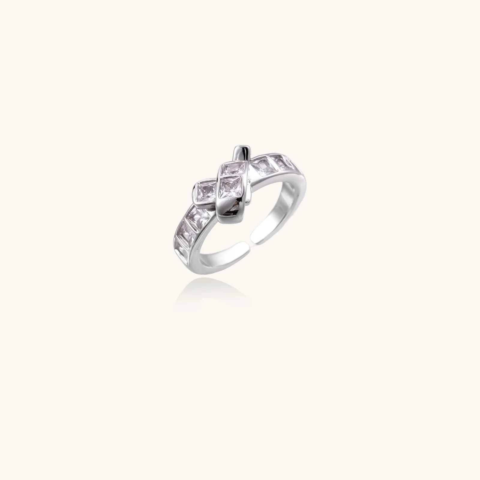 White gold plated adjustable ring featuring offset square cubic zirconia stones in an architectural stacked design