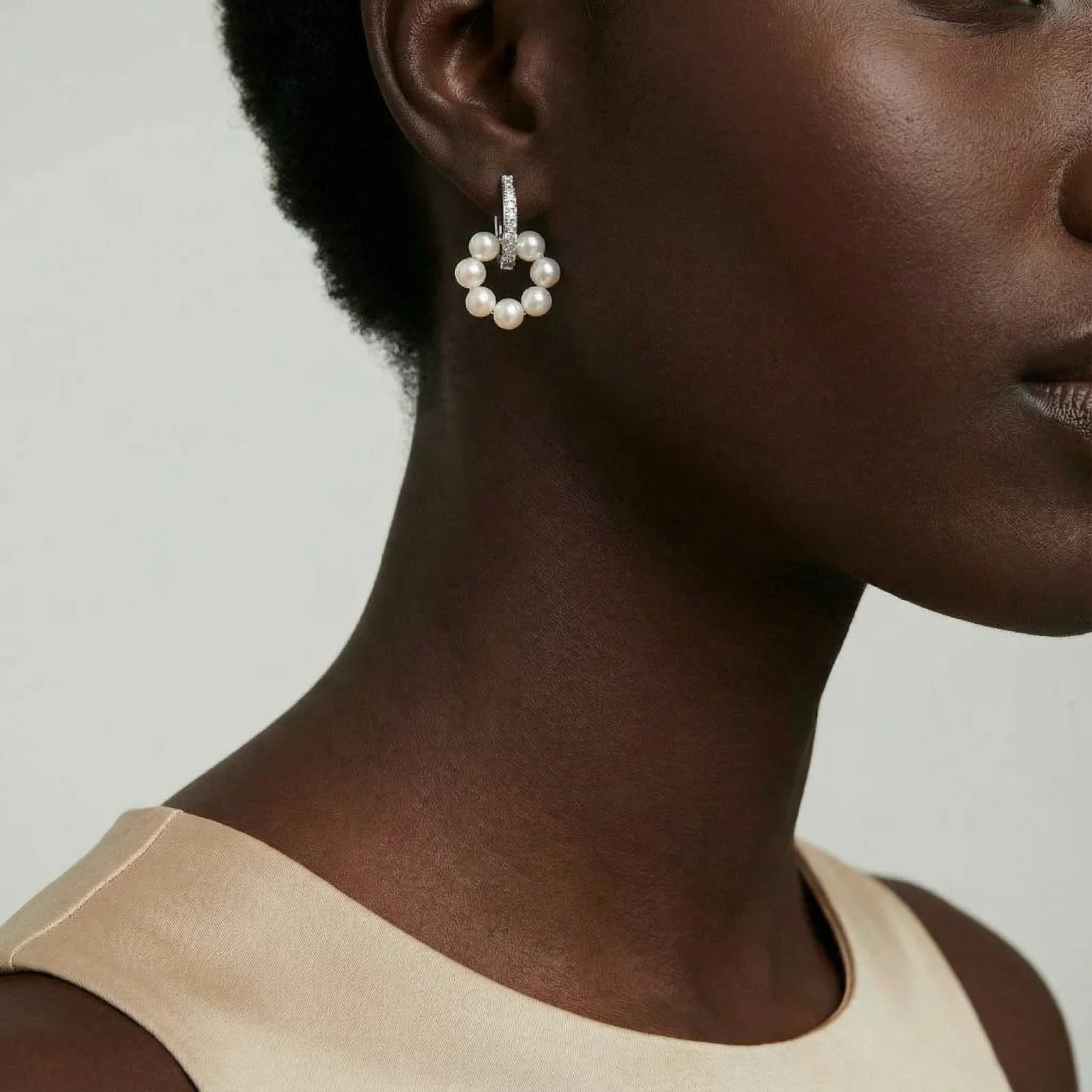 Rhodium-plated silver hoop earrings with freshwater pearls arranged in crescent formation and diamond accents