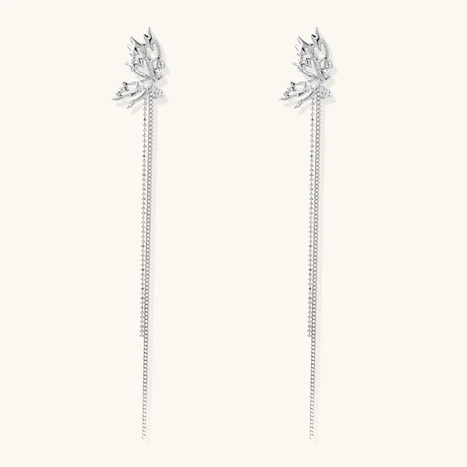 Silver-toned threader earrings featuring detailed fairy figure with wings and dual delicate chain strands, zirconia accents