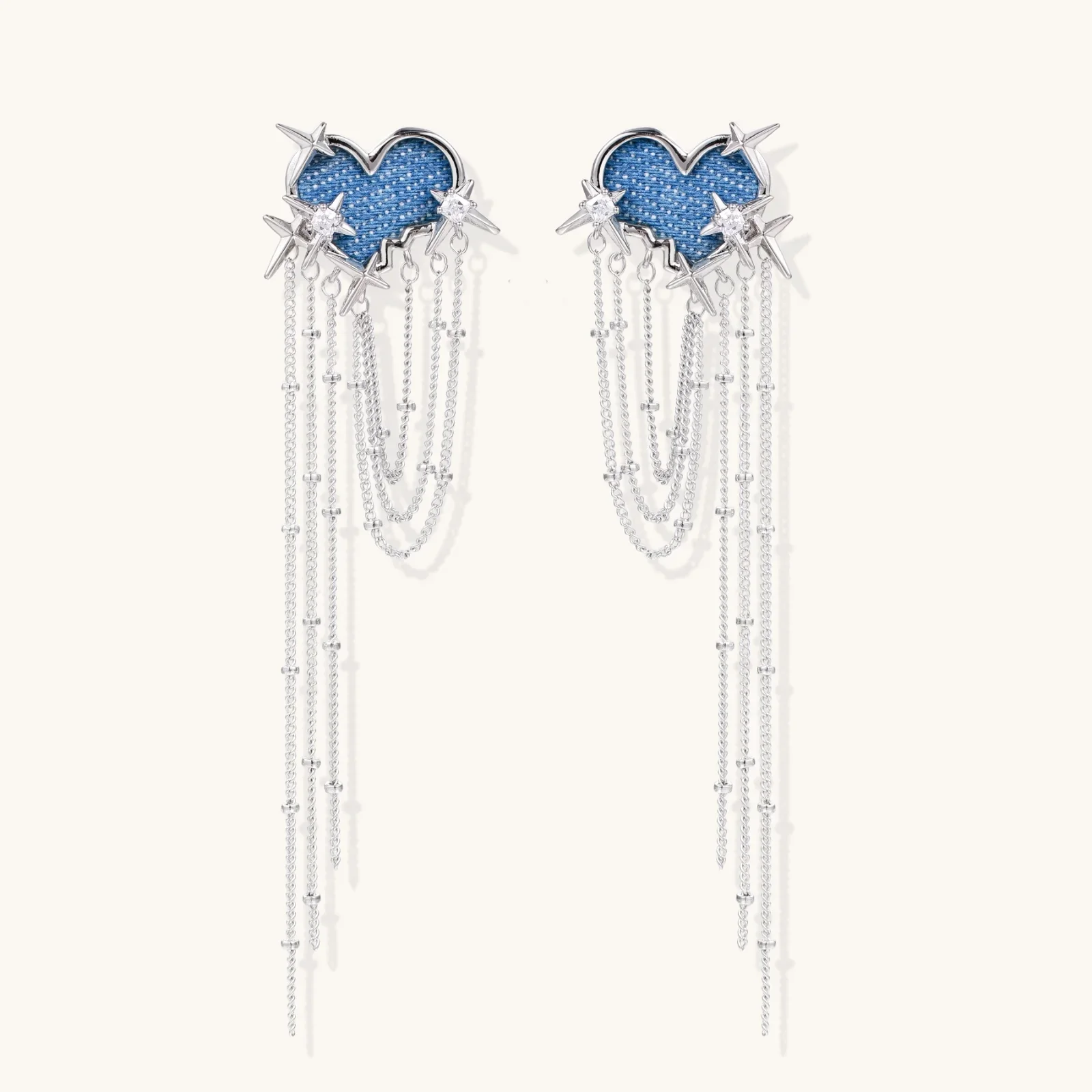 Blue denim cloud-shaped earrings with white gold plated chains, zirconia stars, and cascading silver chain details