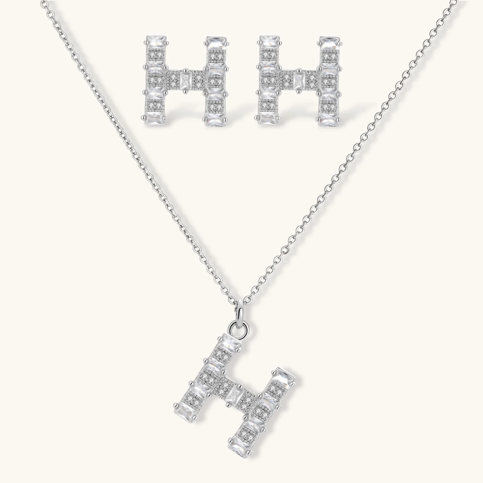 Letter H jewelry set featuring geometric crystal design in gold and white gold plated finish with adjustable chain necklace