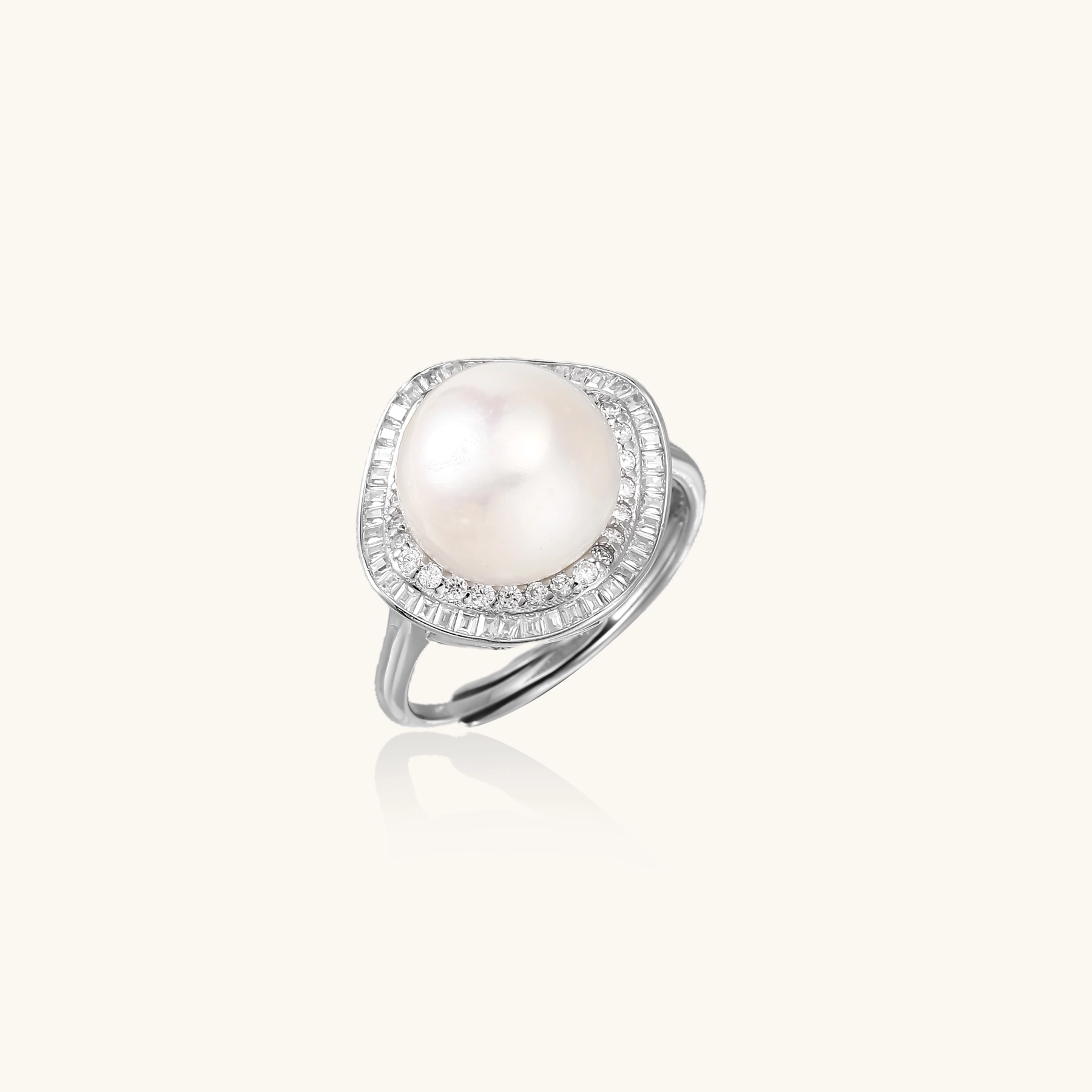 Rhodium-plated silver ring with round pearl center, double halo of baguette and round crystals forming cushion shape