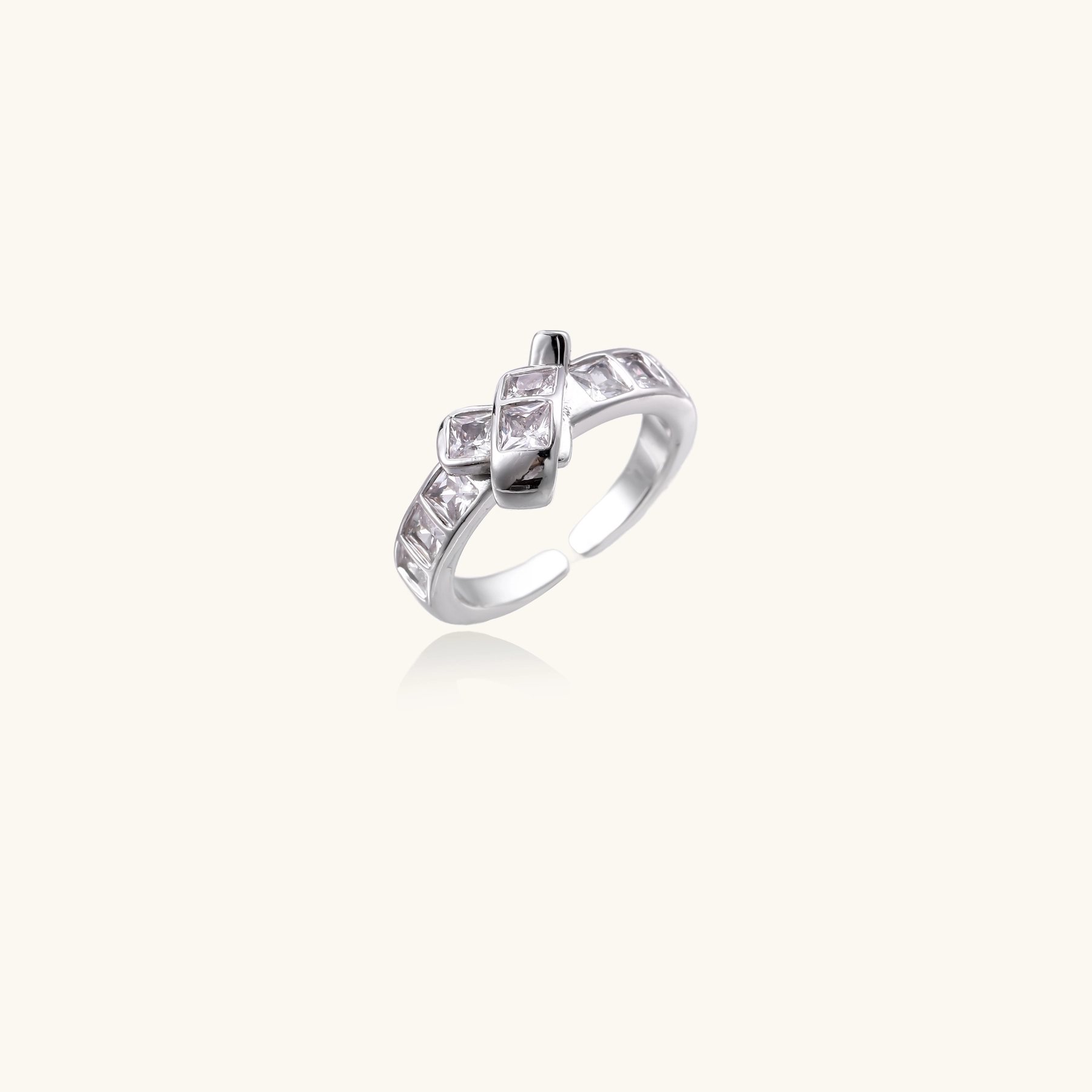 White gold plated adjustable ring featuring offset square cubic zirconia stones in an architectural stacked design