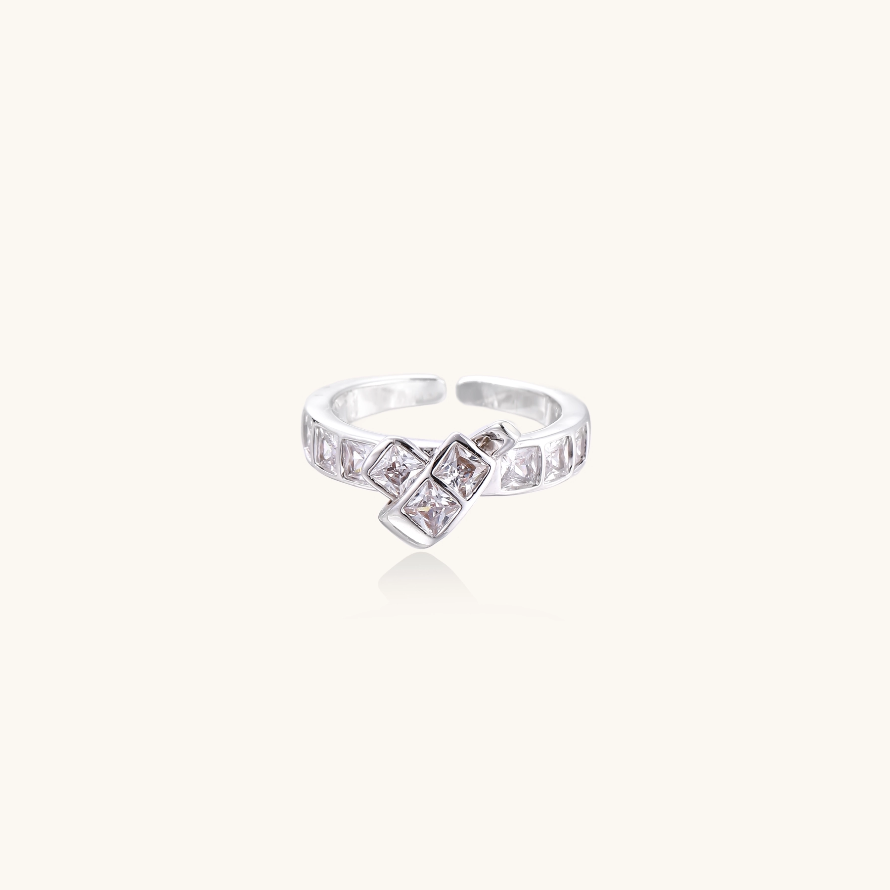White gold plated adjustable ring featuring offset square cubic zirconia stones in an architectural stacked design