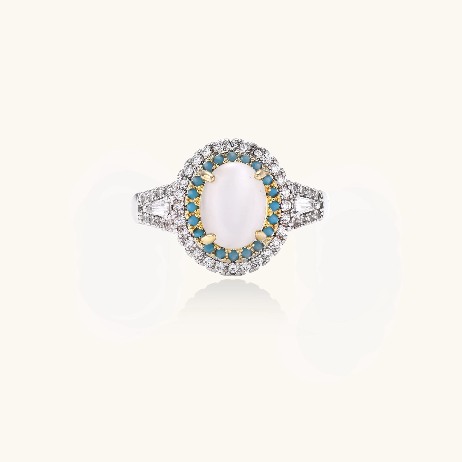 Vintage-style cocktail ring with luminous cat's eye center stone surrounded by turquoise and crystal double halo on white gold plated band