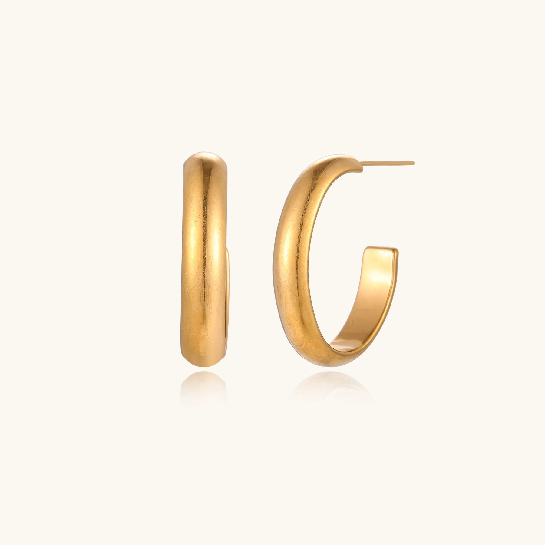 Chunky brushed gold hoop earrings in 14K plated stainless steel on cream background, front and side view.