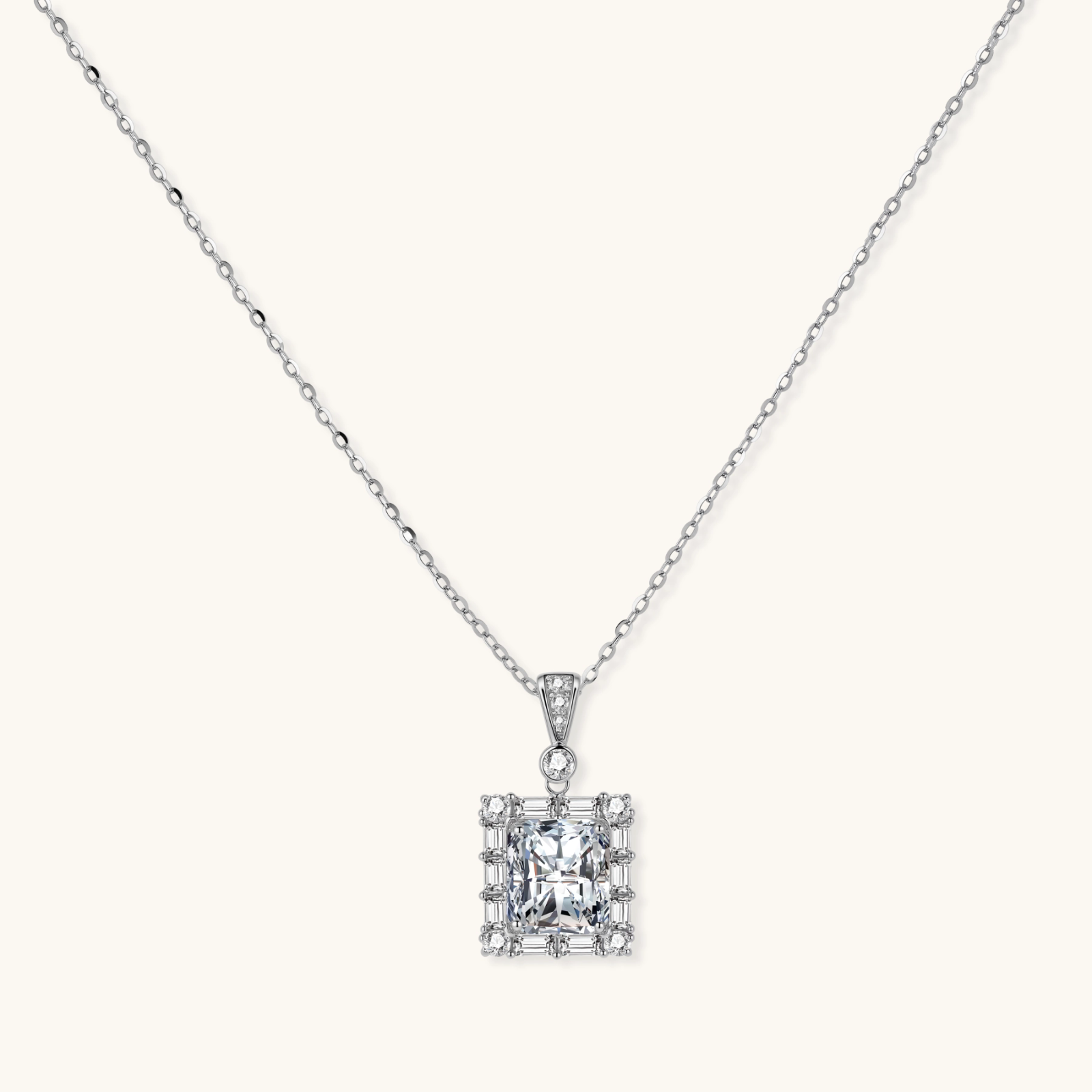 Square moissanite pendant with halo setting on delicate sterling silver chain against white background.