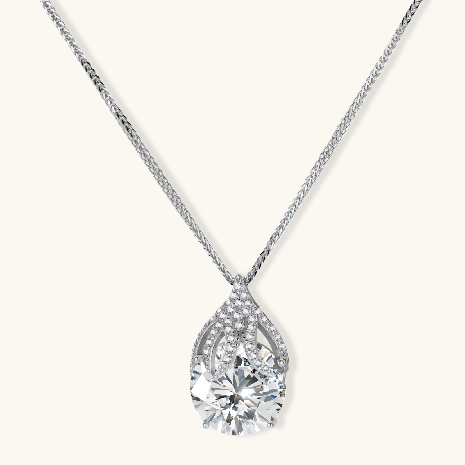 Sterling silver necklace featuring a large pear-shaped moissanite stone in an ornate setting with smaller accent stones