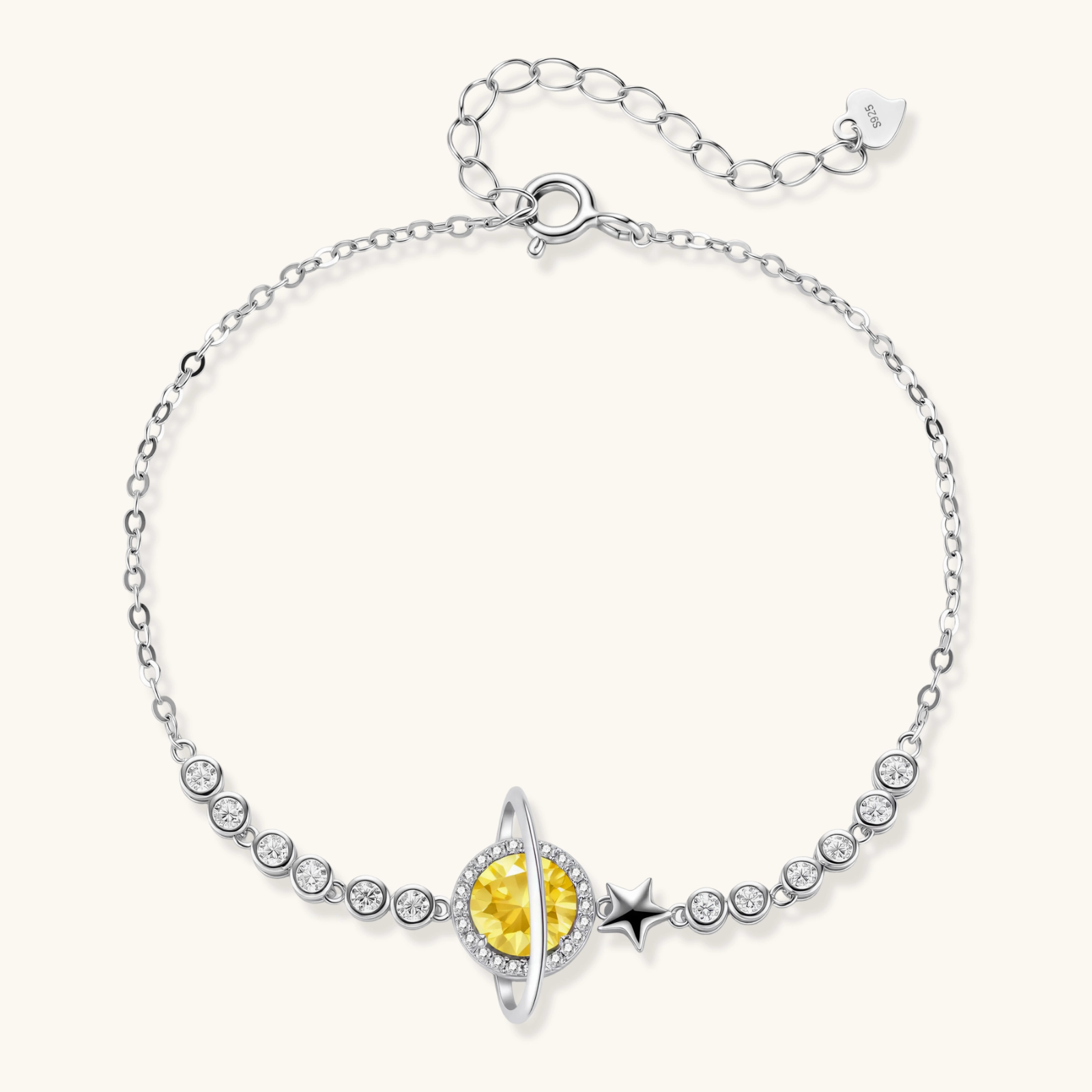 Sterling silver bracelet with yellow moissanite centerpiece in oval setting, crystal chain, and star charm on white background.