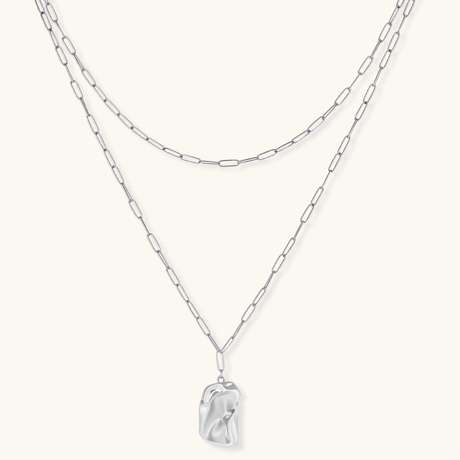 Layered paperclip chain necklace with organic flowing pendant made from eco-zinc alloy in warm gold finish