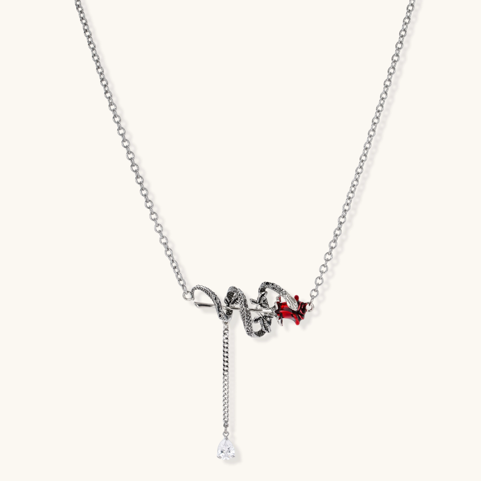 Detailed eco-brass serpent pendant necklace with red zirconia stone and crystal drop tassel on adjustable chain