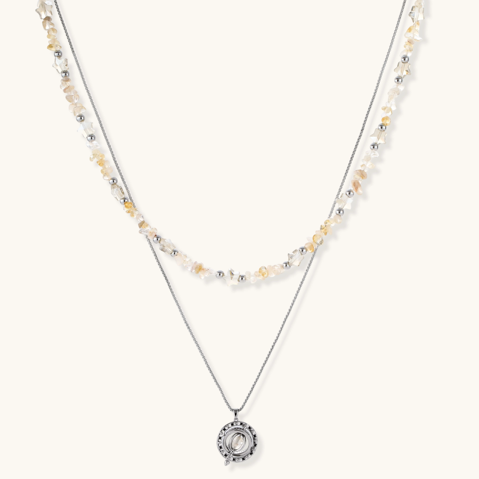 Two-layer necklace with natural stone chips and eco-brass beads, featuring a circular wrapped pendant on cream background.