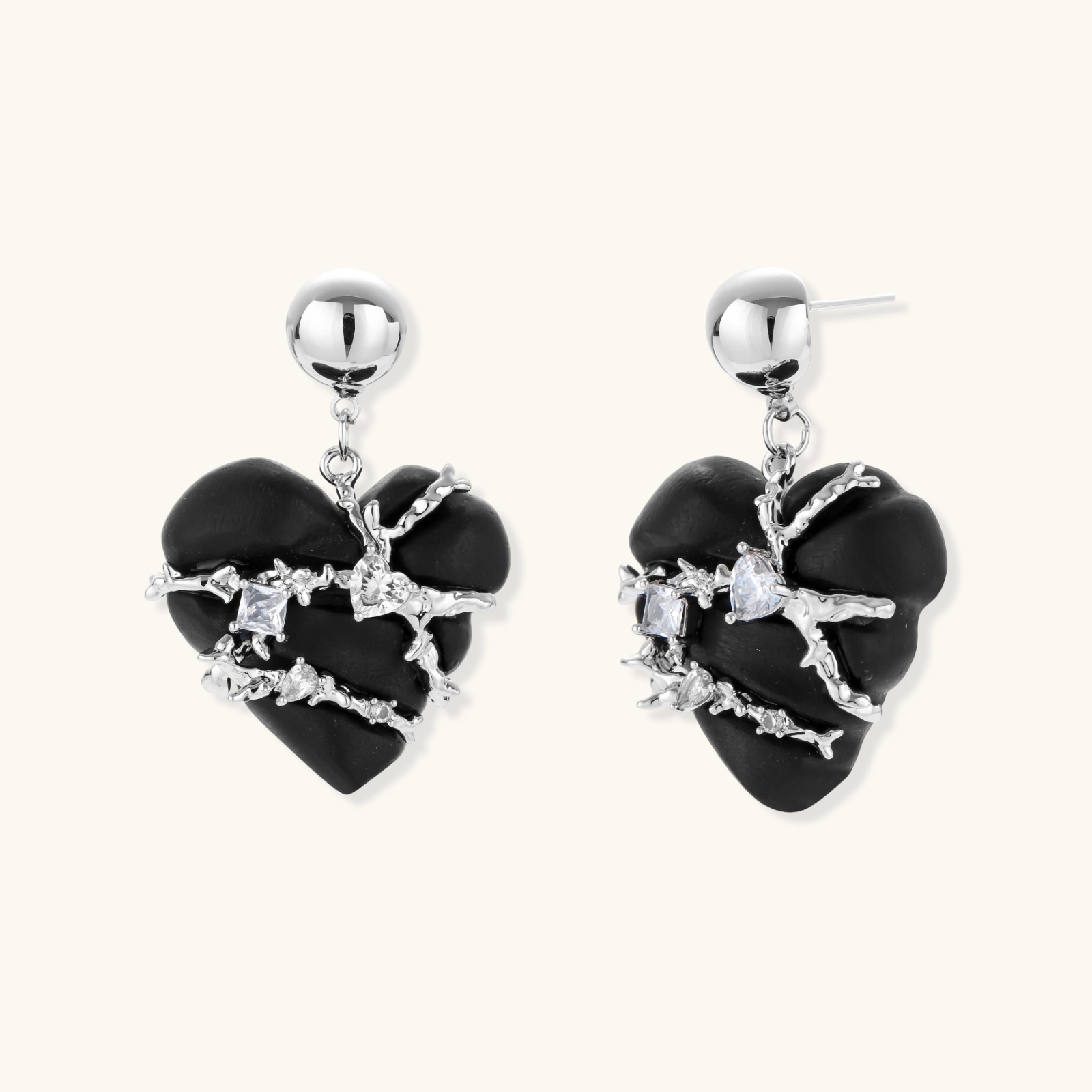 Heart-shaped wood earrings wrapped in silver wire with zirconia crystals, featuring ball stud posts on white background.