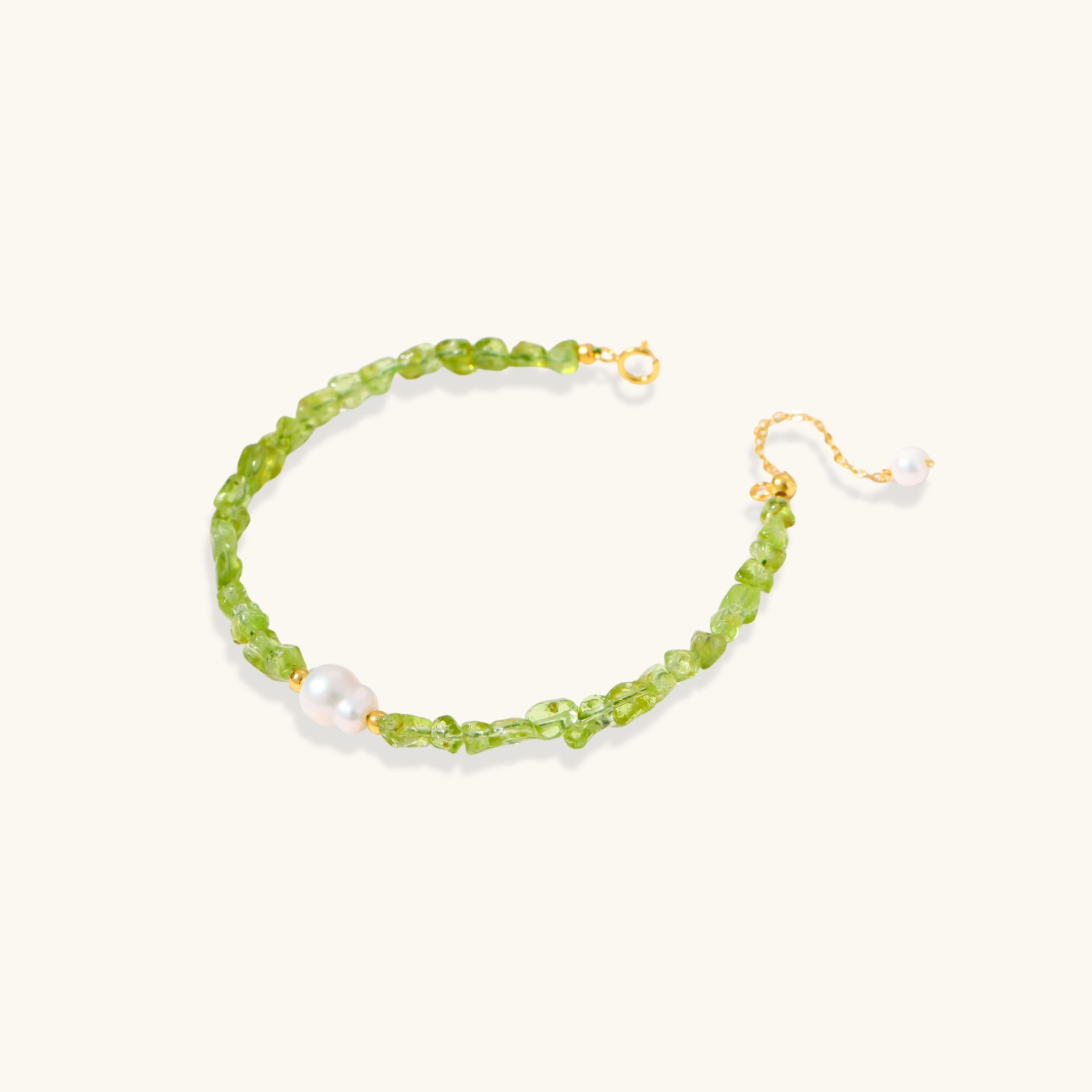 Delicate sterling silver bracelet with lime-green peridot gemstone chips and single freshwater pearl centerpiece