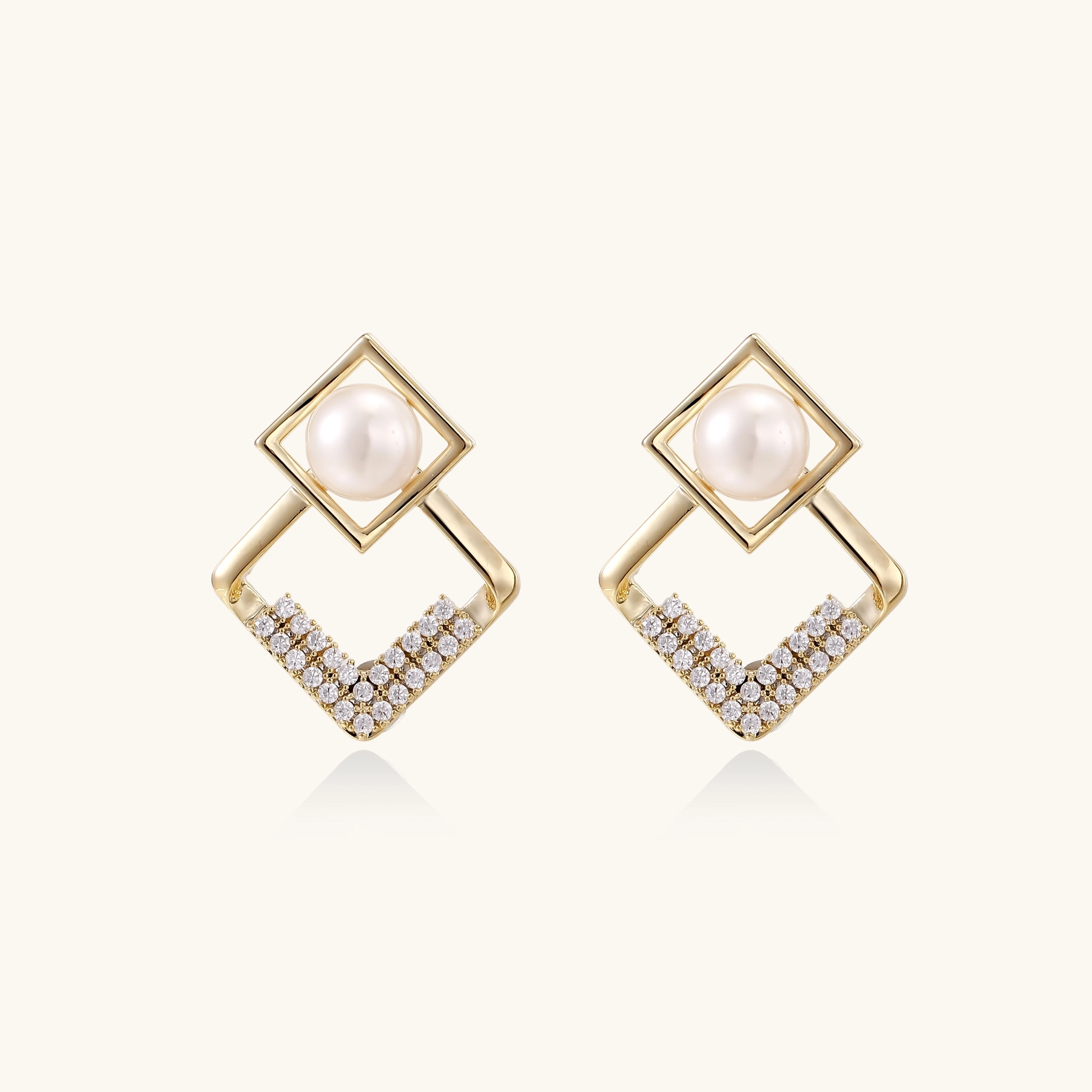 Gold-plated double square frame earrings with freshwater pearl and crystal accents on white background