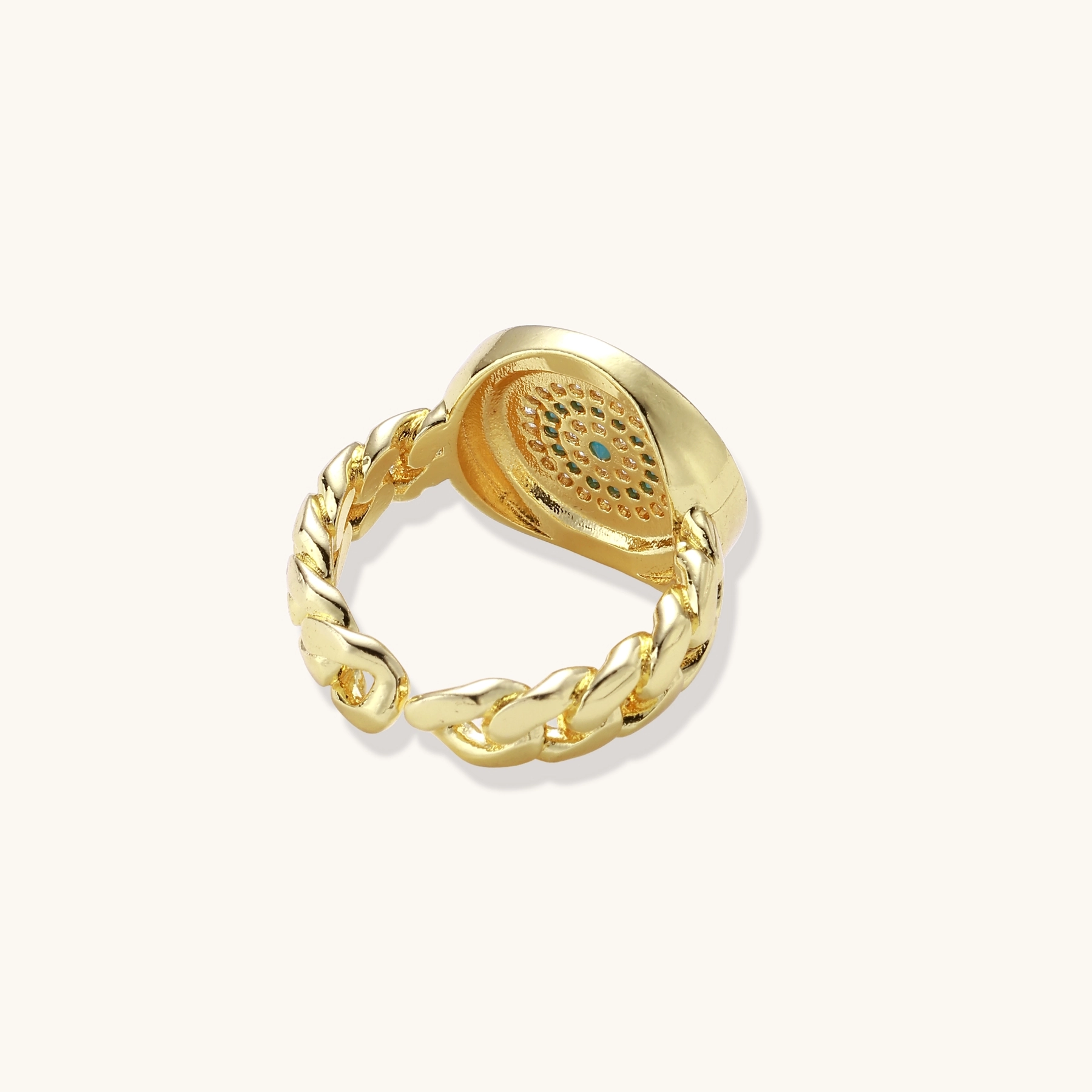 Gold chain ring with Greek key border and turquoise evil eye center on white background
