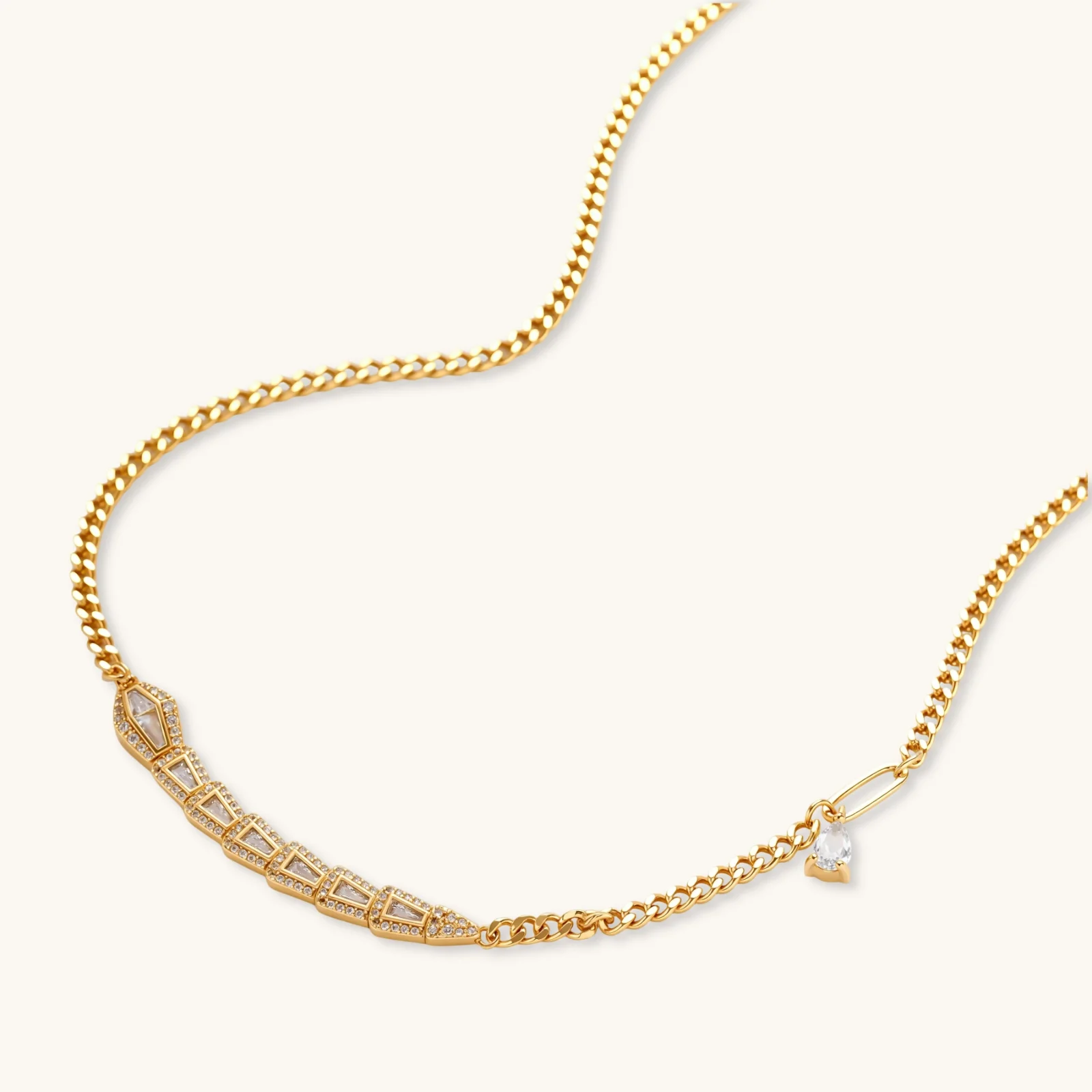 Gold-plated necklace with geometric diamond segments and matching huggie earrings featuring cubic zirconia details