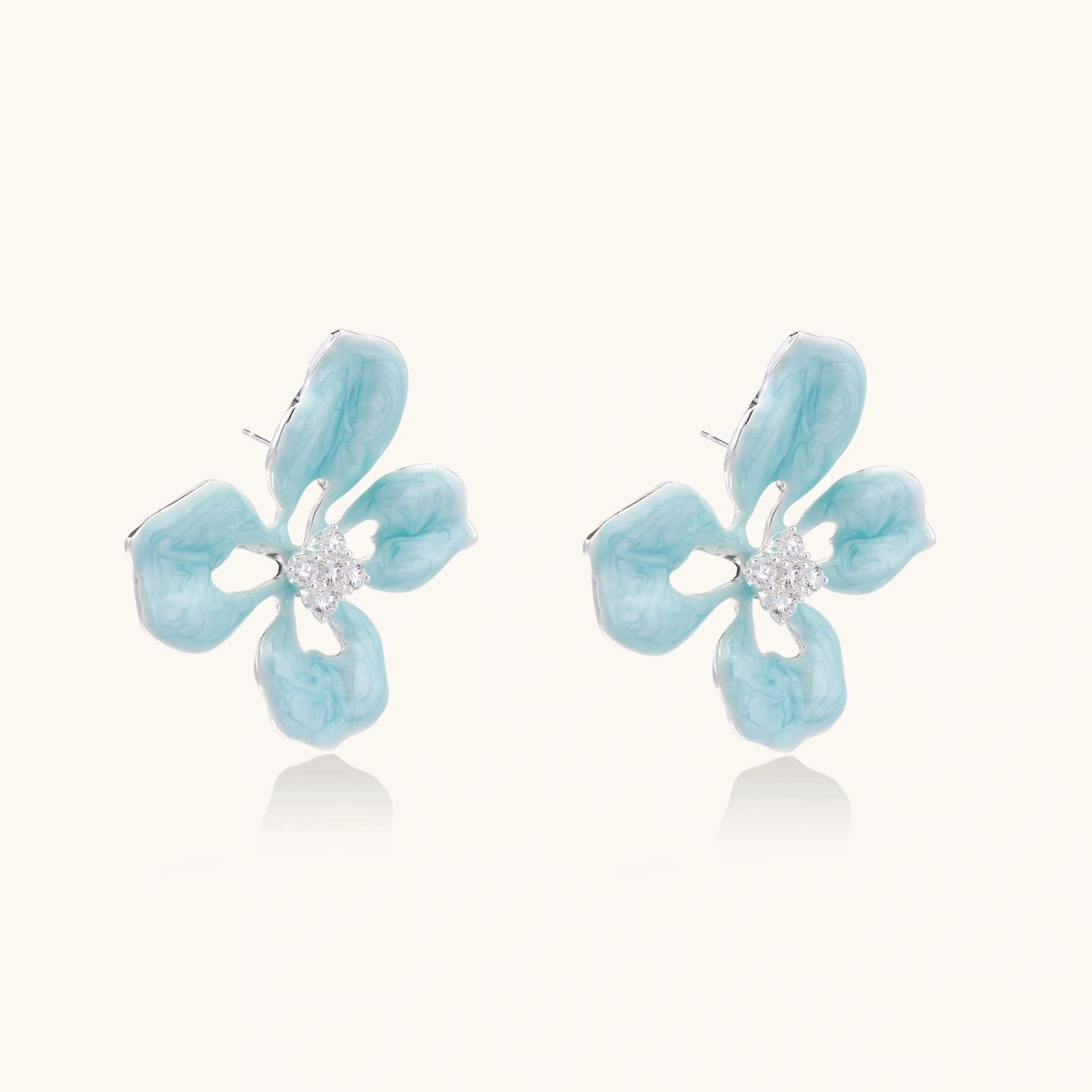 Turquoise enamel flower stud earrings with marbled finish and crystal centers on 18K gold plated brass