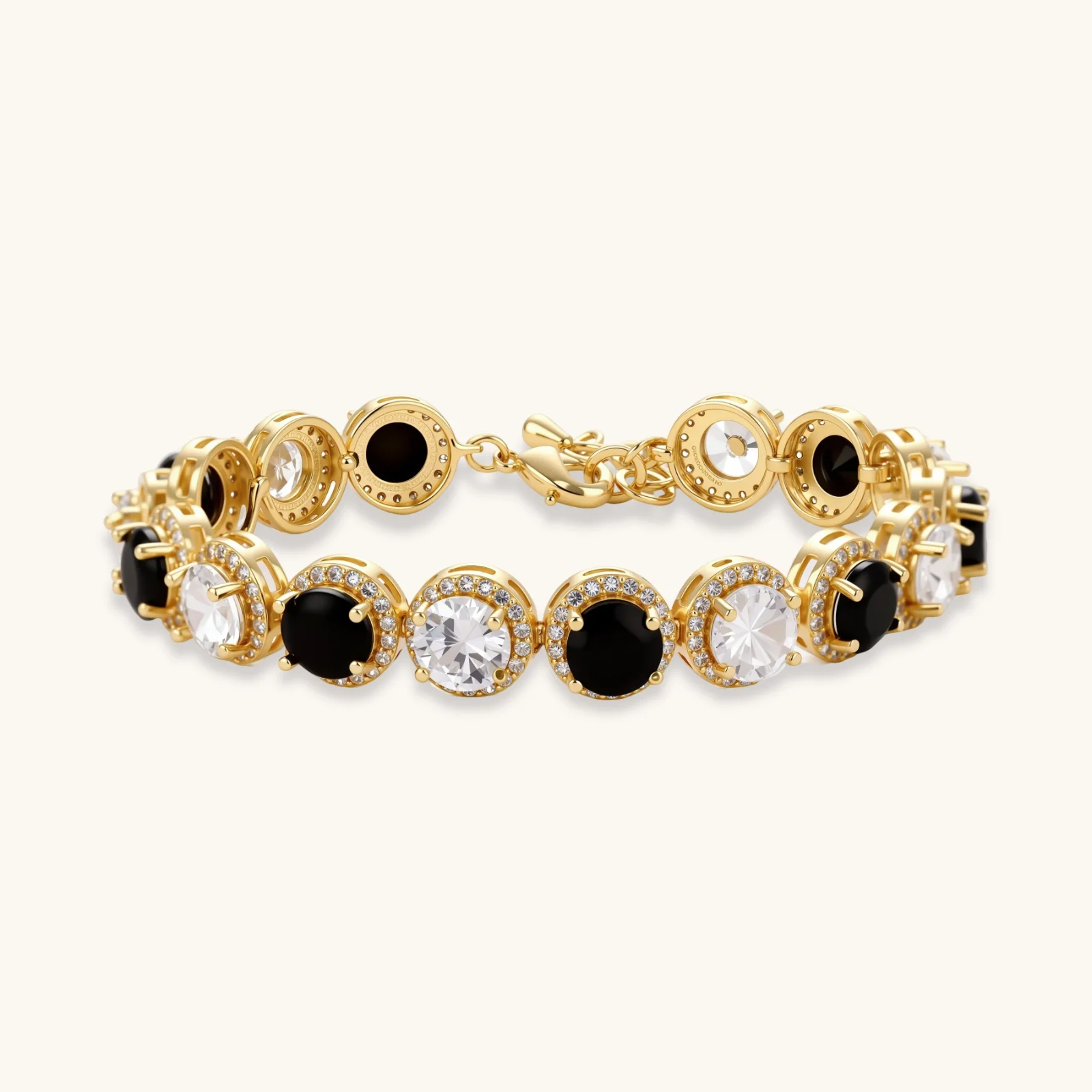 Gold-plated jewelry set with alternating black and clear cubic zirconia stones, featuring necklace, earrings and bracelet