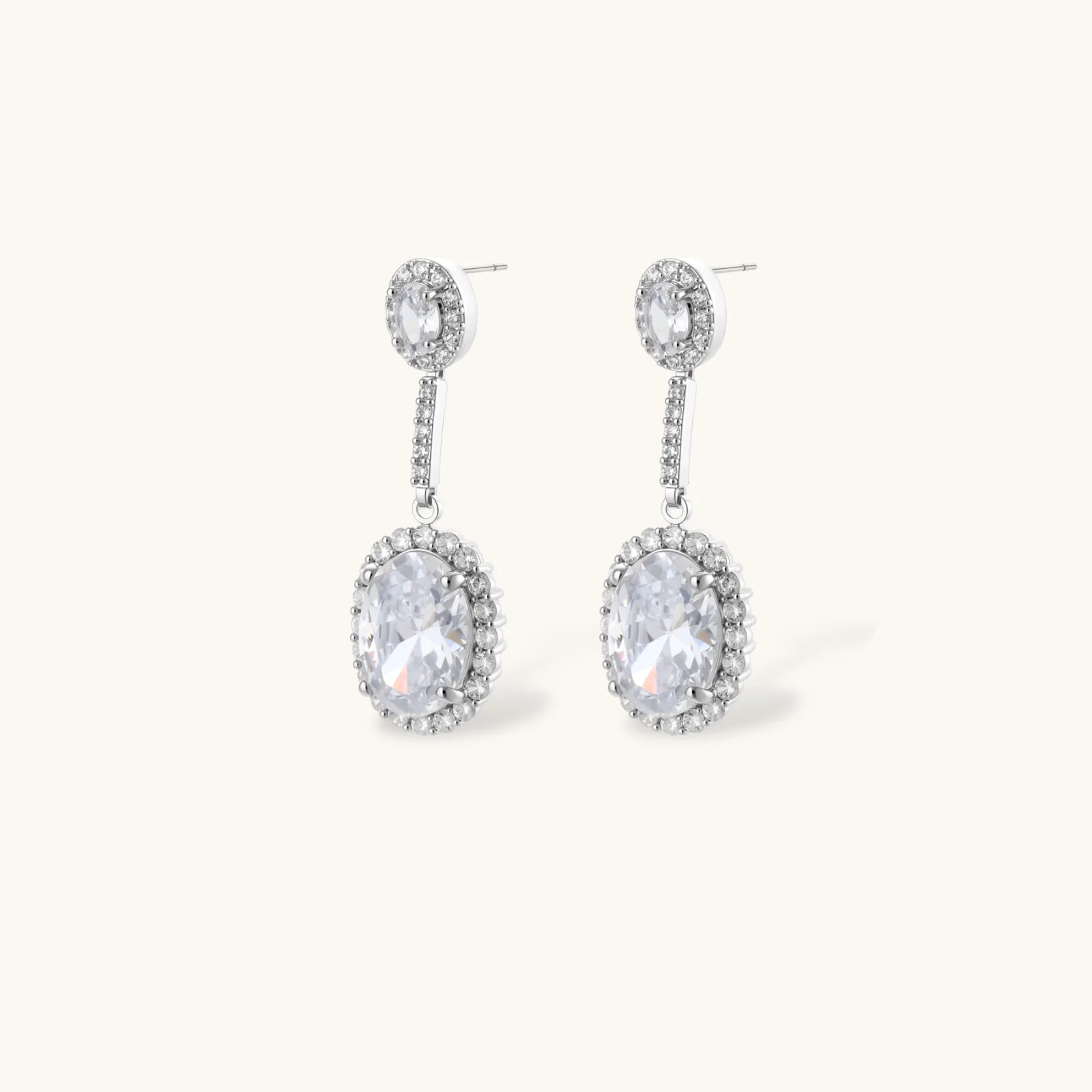 Elegant white gold plated jewelry set with oval cubic zirconia stones in halo settings, featuring Y-necklace and drop earrings.