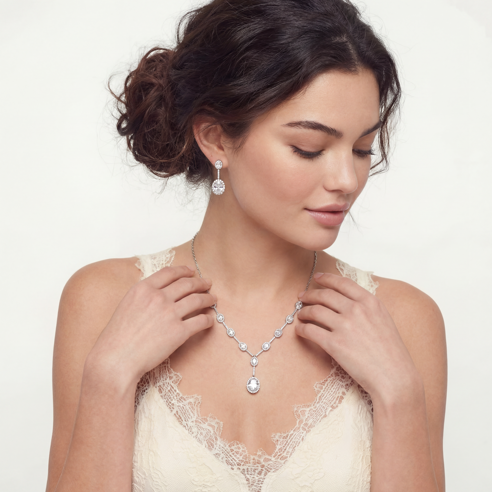 Elegant white gold plated jewelry set with oval cubic zirconia stones in halo settings, featuring Y-necklace and drop earrings.