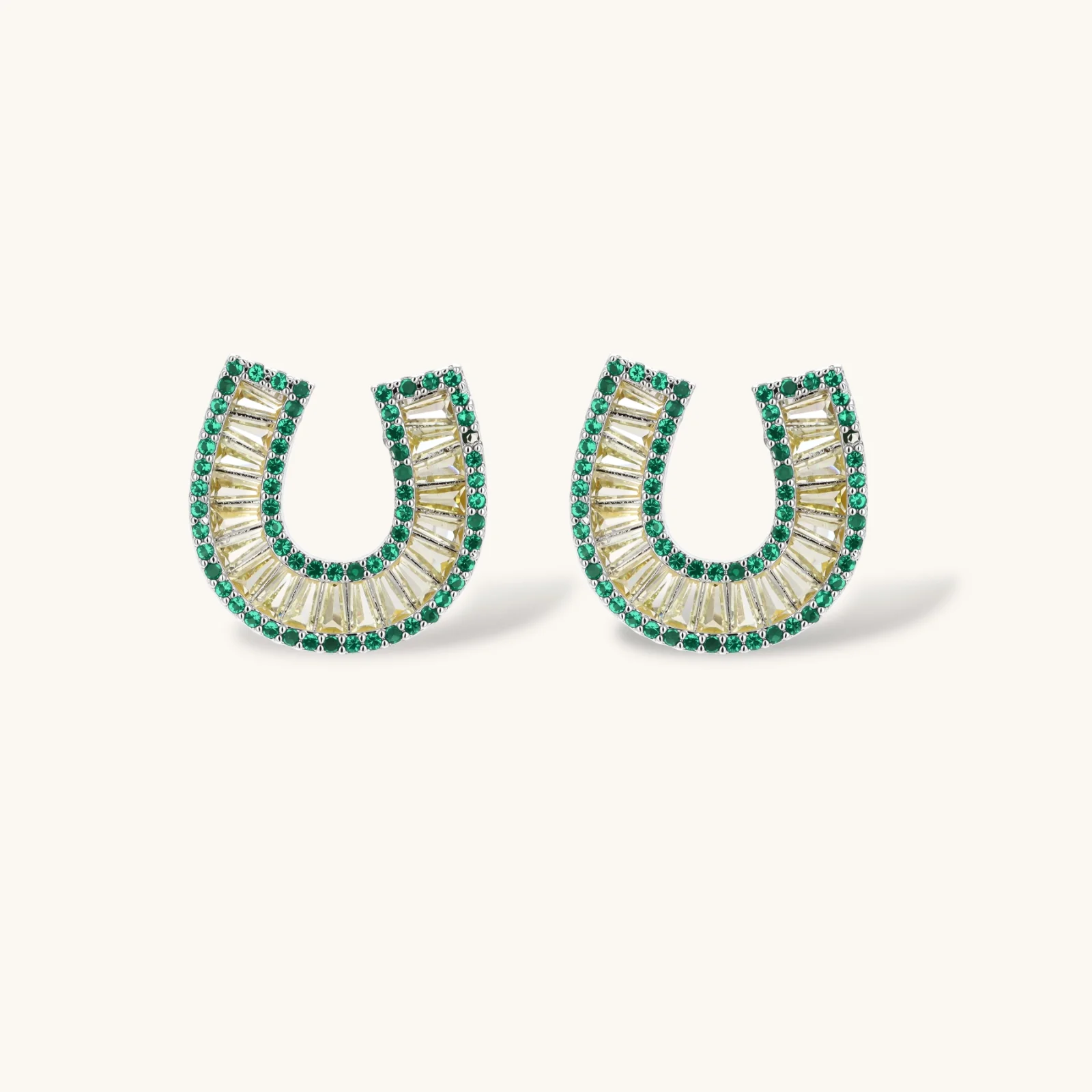 Sparkling horseshoe-shaped jewelry set with AAA cubic zirconia in gold-plated and white gold finishes on cream background.