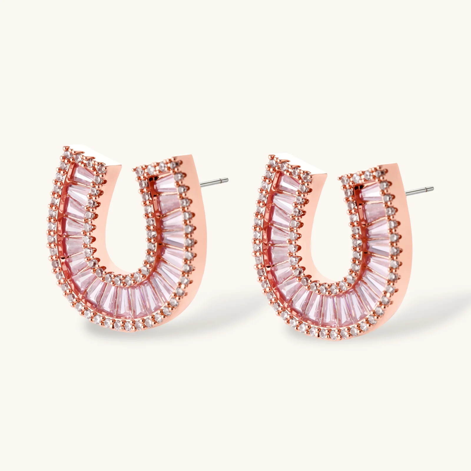 Sparkling horseshoe-shaped jewelry set with AAA cubic zirconia in gold-plated and white gold finishes on cream background.