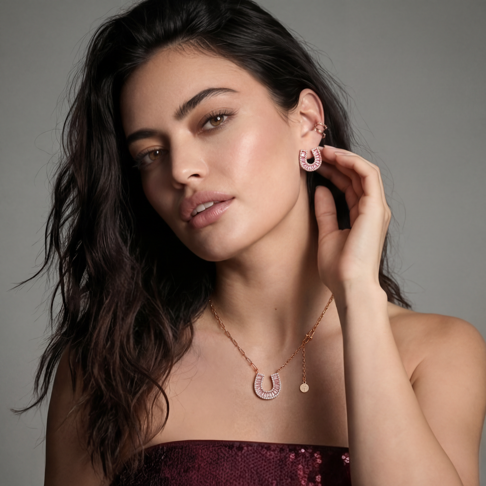 Sparkling horseshoe-shaped jewelry set with AAA cubic zirconia in gold-plated and white gold finishes on cream background.