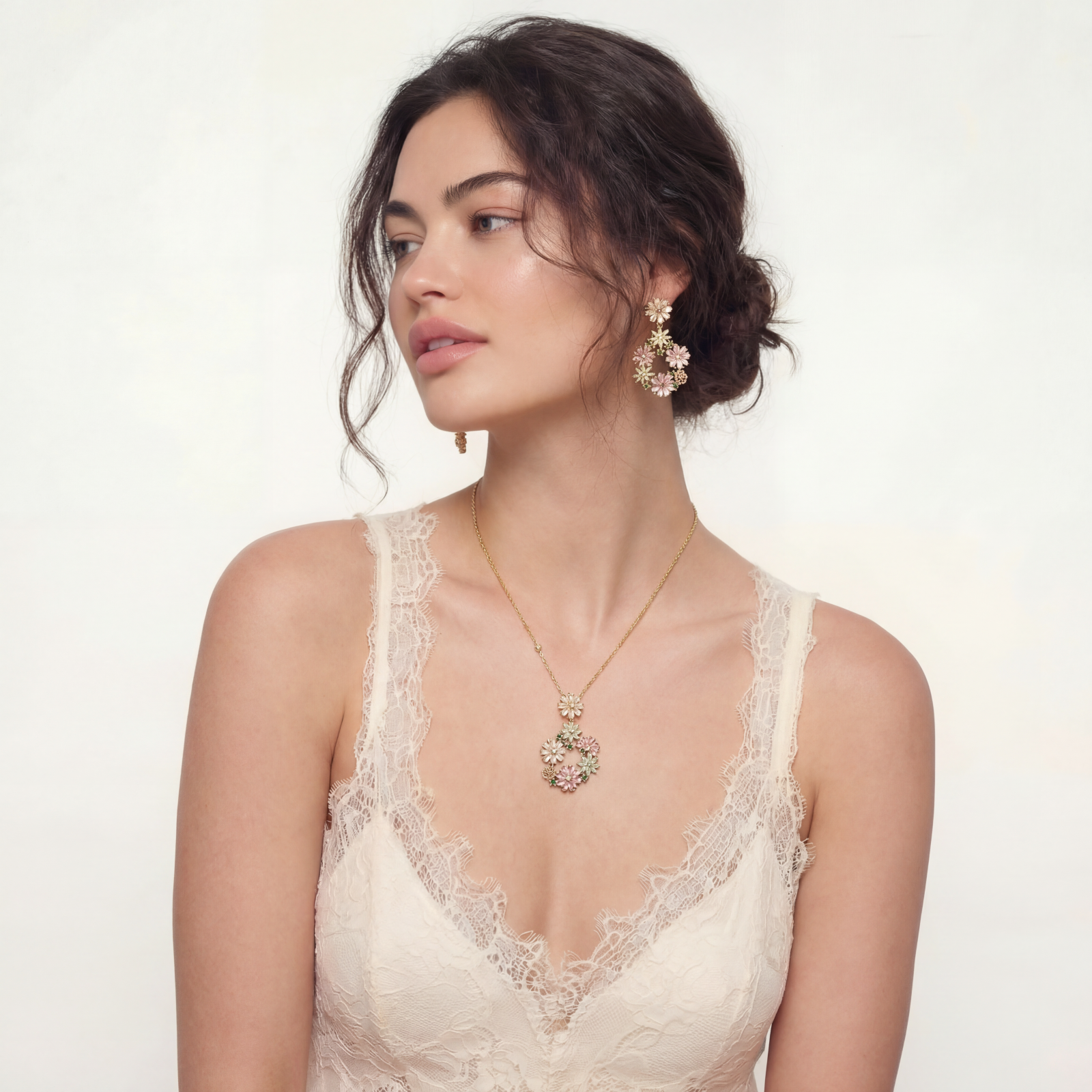 14K gold plated jewelry set with pink and green cubic zirconia flowers arranged in wreath design on cream background