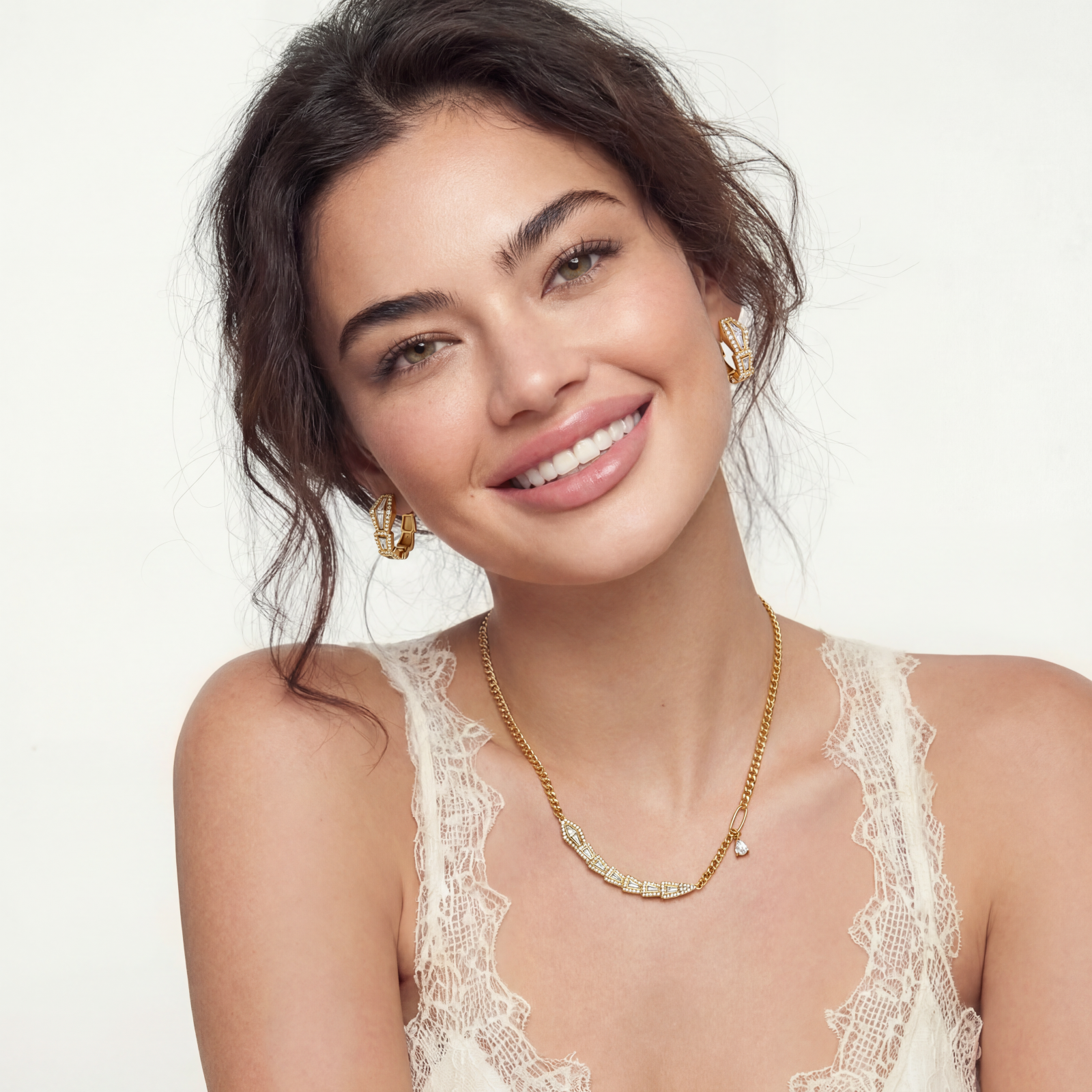 Gold-plated necklace with geometric diamond segments and matching huggie earrings featuring cubic zirconia details