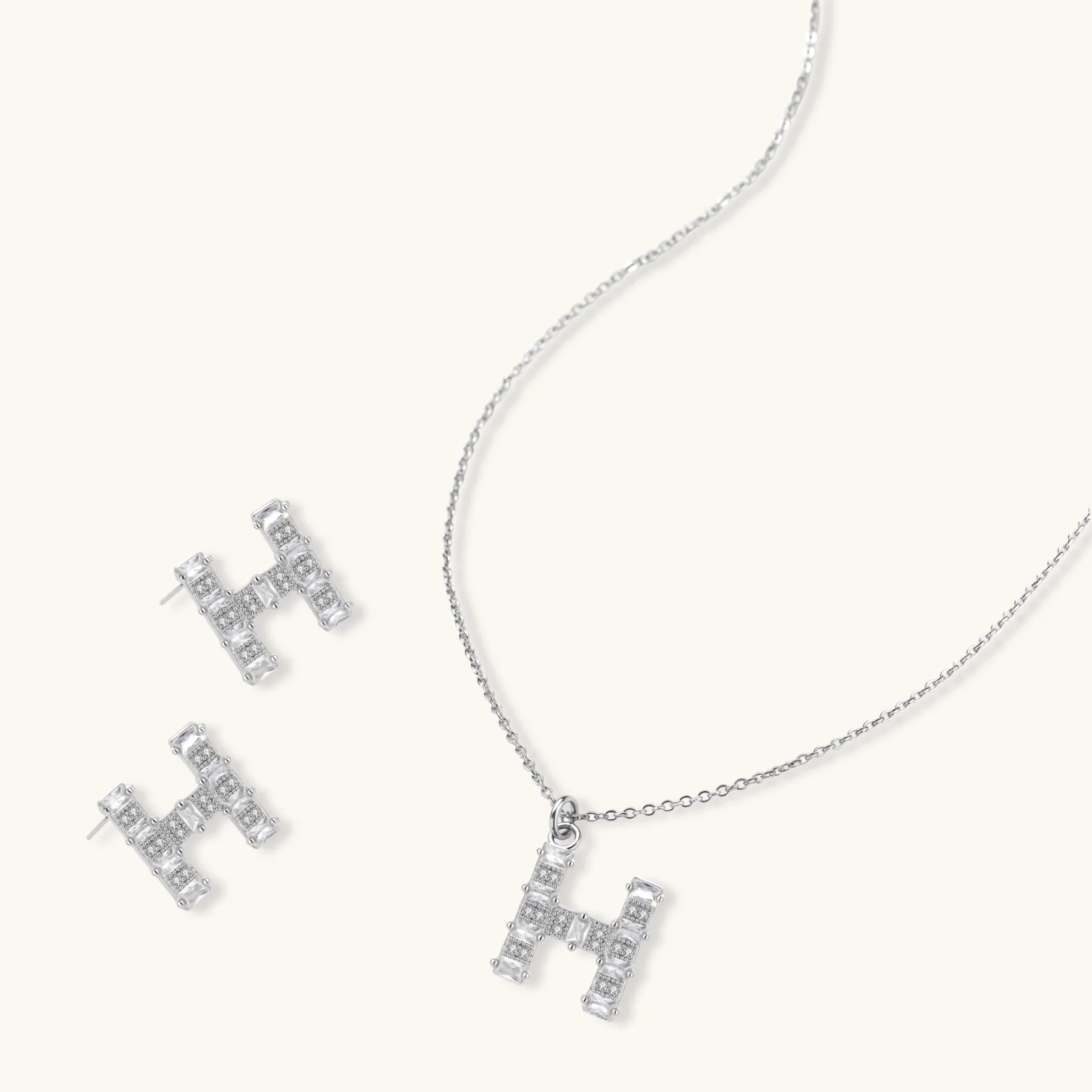 Letter H jewelry set featuring geometric crystal design in gold and white gold plated finish with adjustable chain necklace