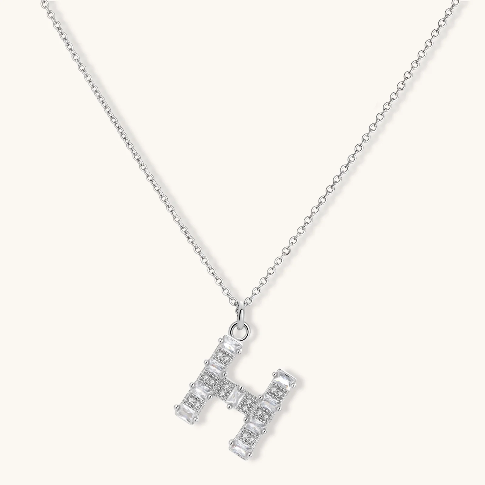 Letter H jewelry set featuring geometric crystal design in gold and white gold plated finish with adjustable chain necklace