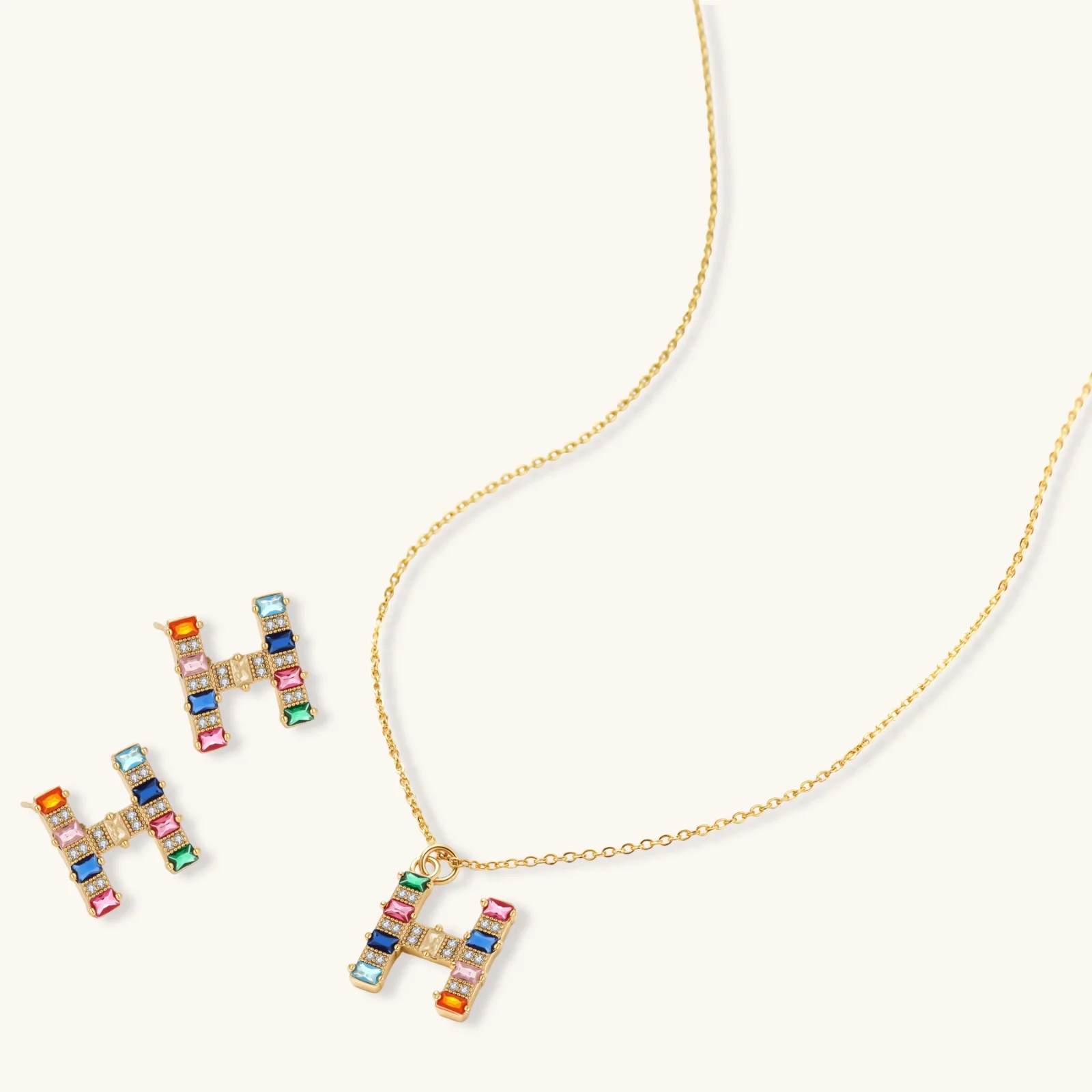 Letter H jewelry set featuring geometric crystal design in gold and white gold plated finish with adjustable chain necklace