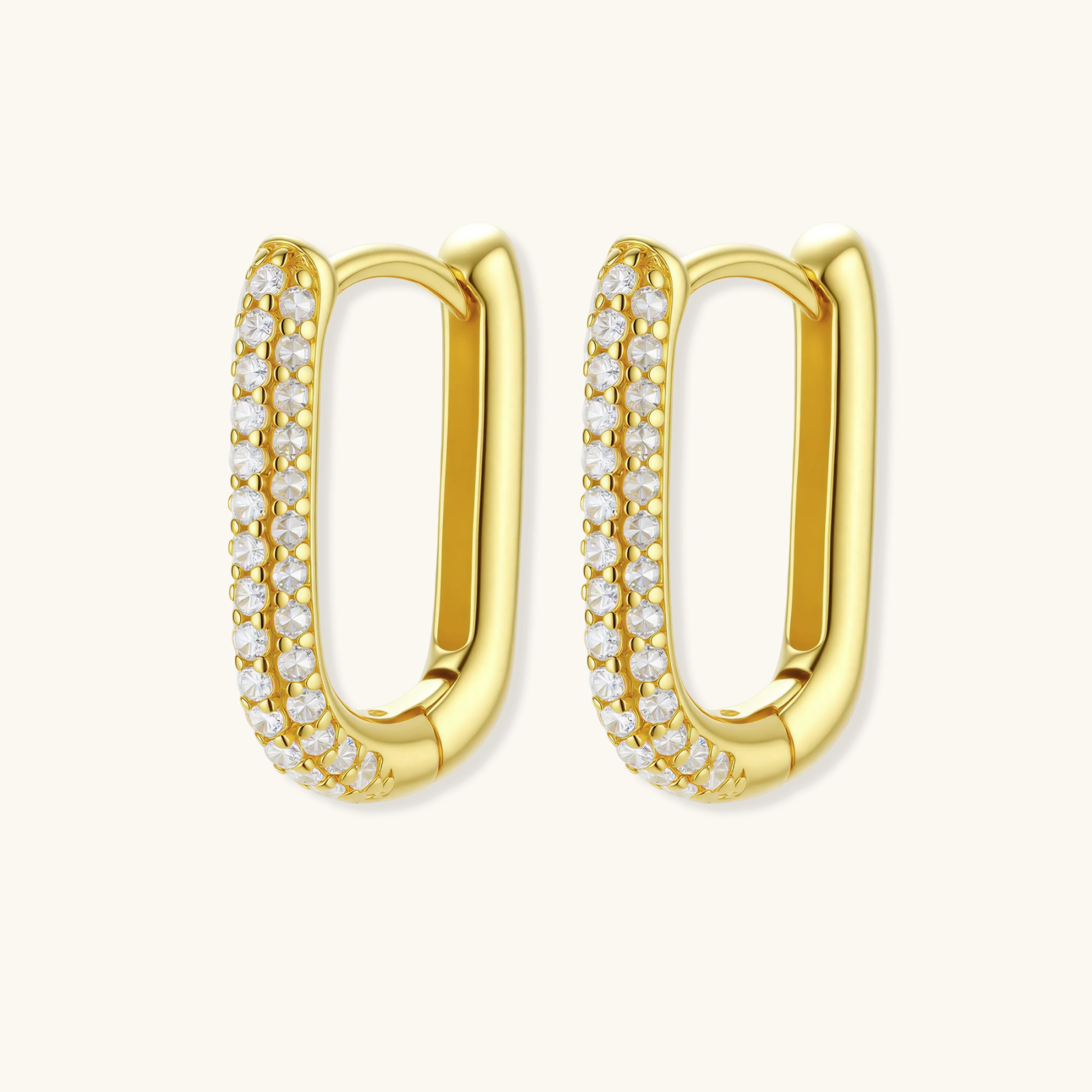 Close-up of small sterling silver huggie hoops completely covered in sparkling clear crystals with hinged closure