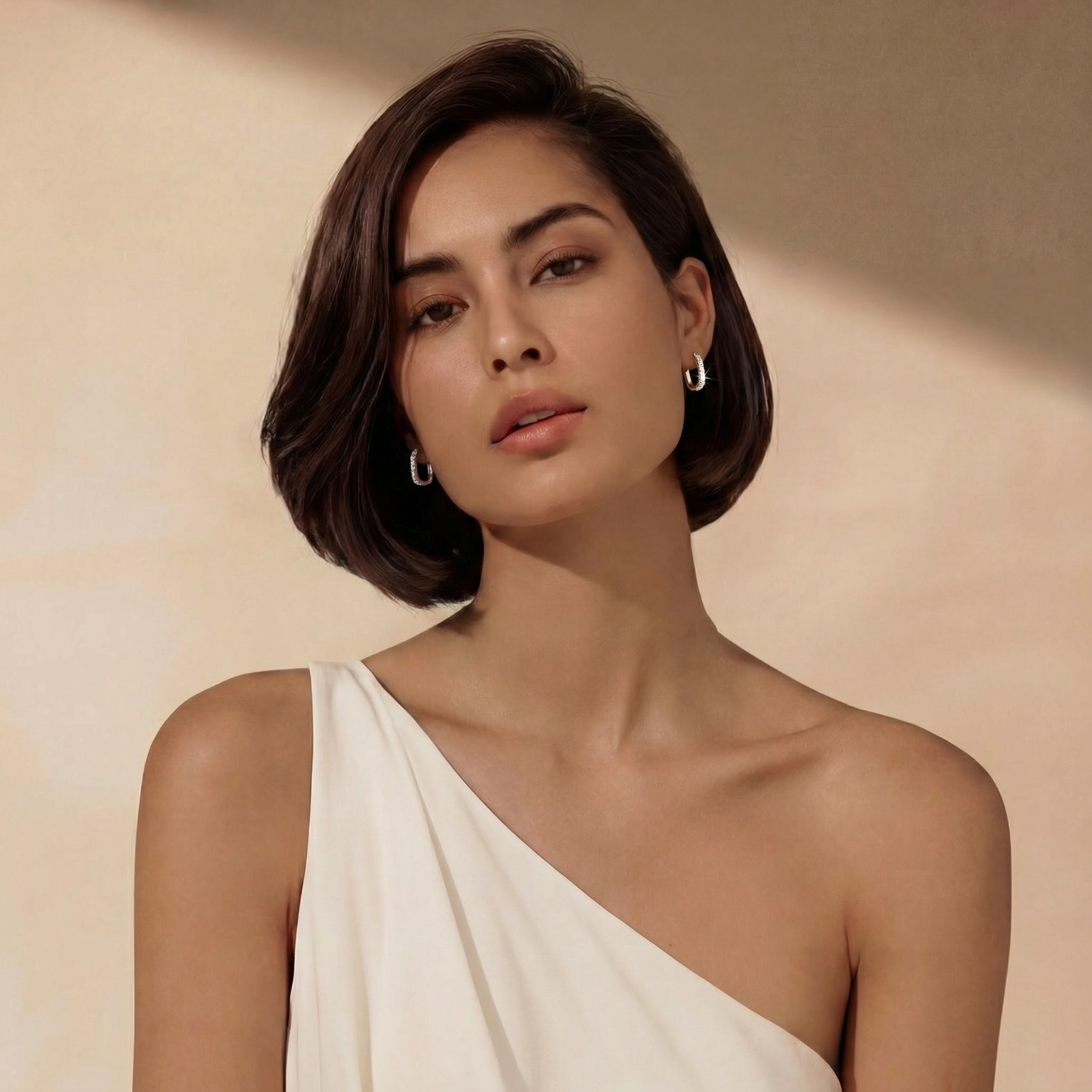 Close-up of small sterling silver huggie hoops completely covered in sparkling clear crystals with hinged closure