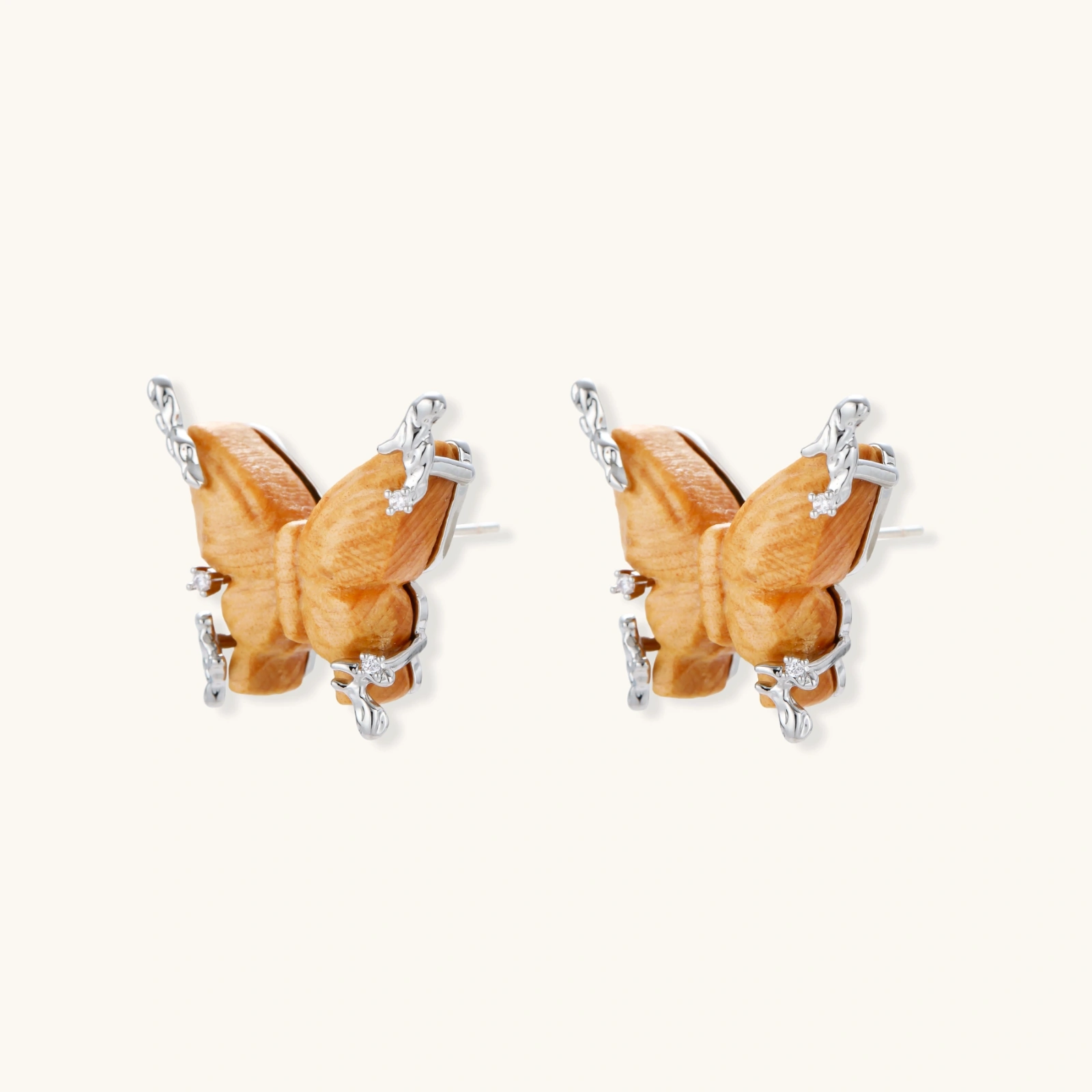 Wooden butterfly earrings with silver chain details in light and dark wood variants on white background
