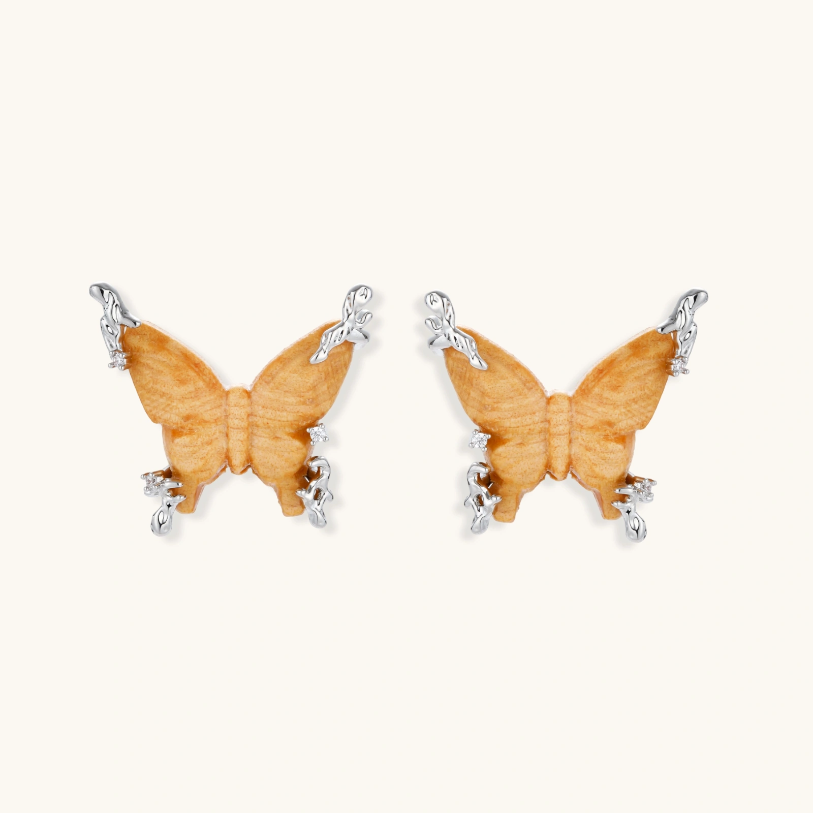 Wooden butterfly earrings with silver chain details in light and dark wood variants on white background