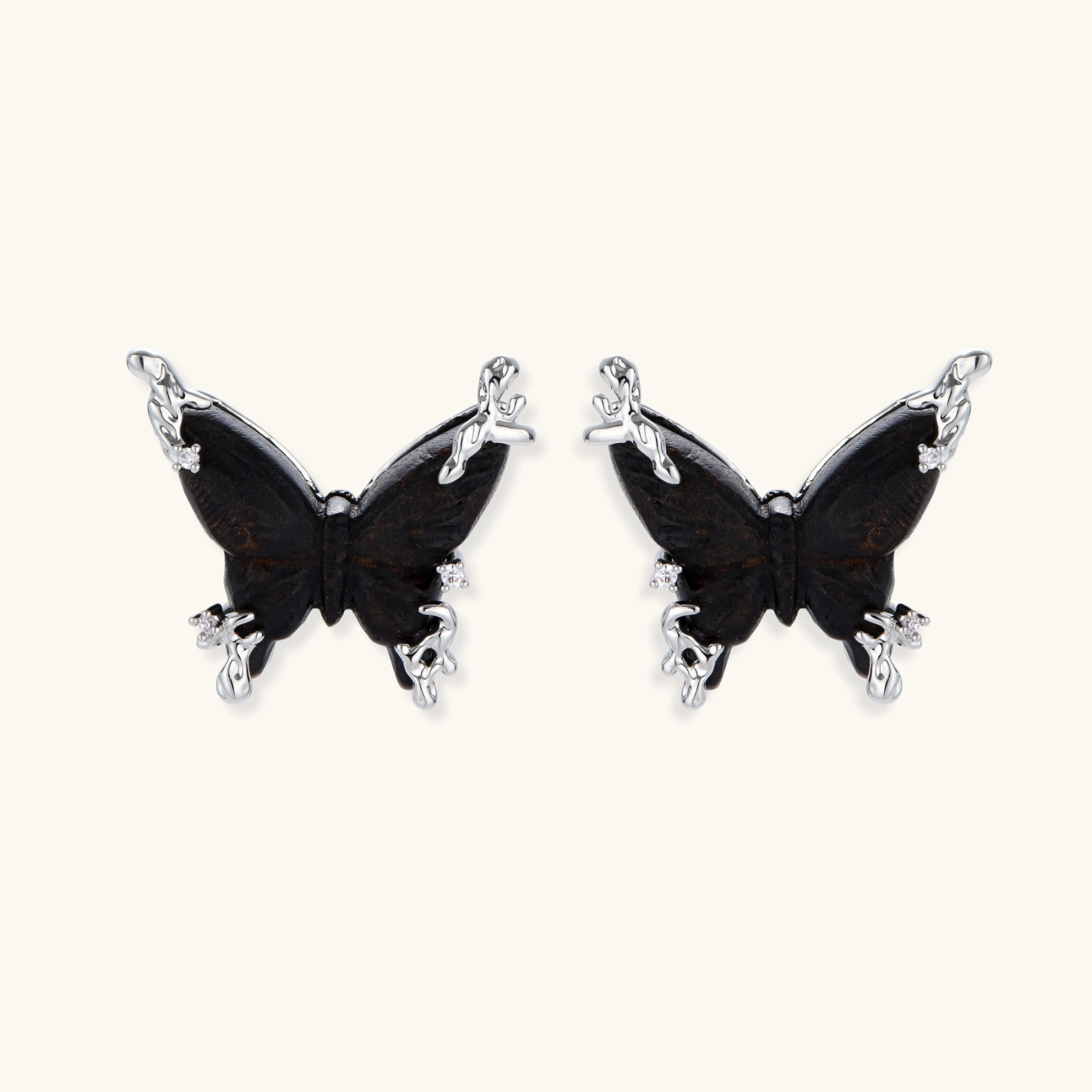 Wooden butterfly earrings with silver chain details in light and dark wood variants on white background