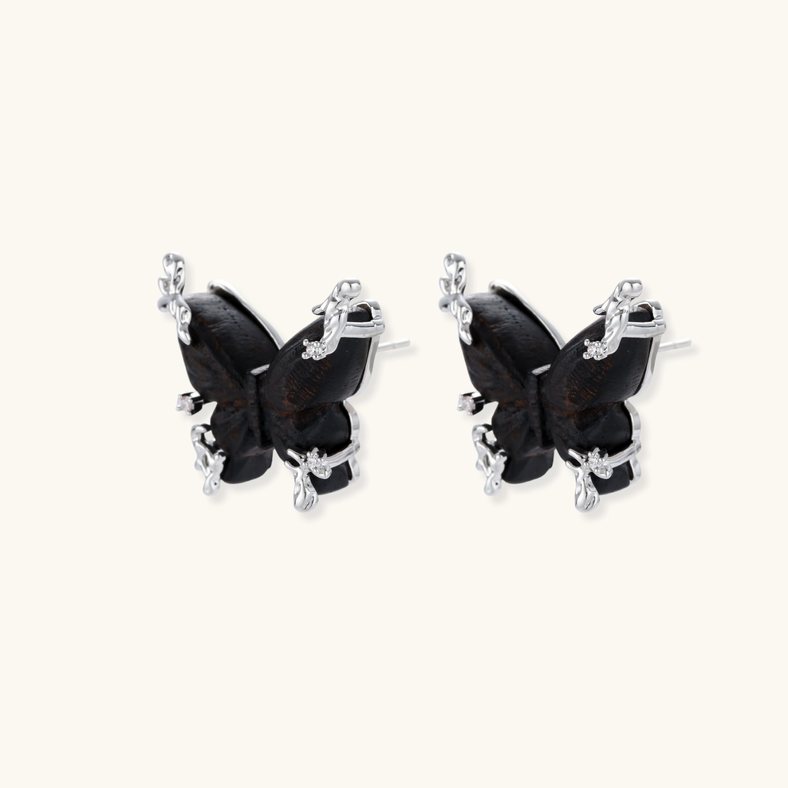 Wooden butterfly earrings with silver chain details in light and dark wood variants on white background