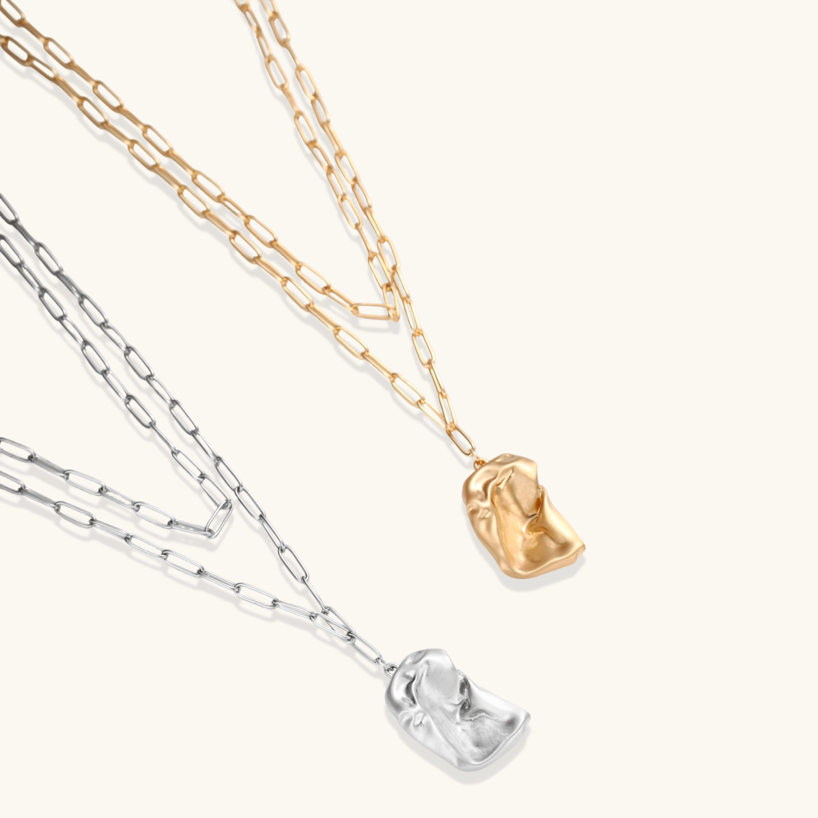 Layered paperclip chain necklace with organic flowing pendant made from eco-zinc alloy in warm gold finish