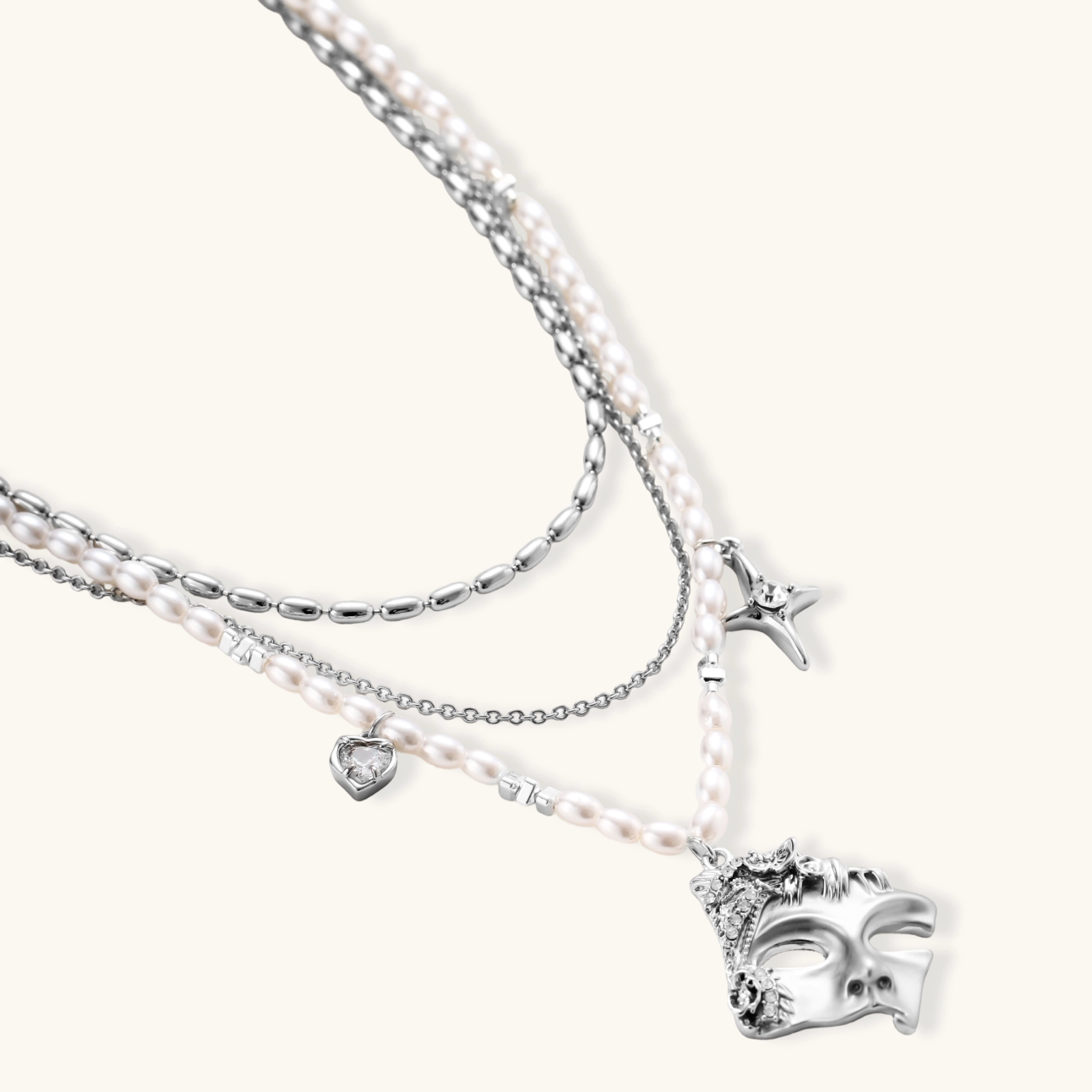 Multi-strand layered necklace set with silver chains, white pearls, star charm, heart pendant, and ornate decorative piece