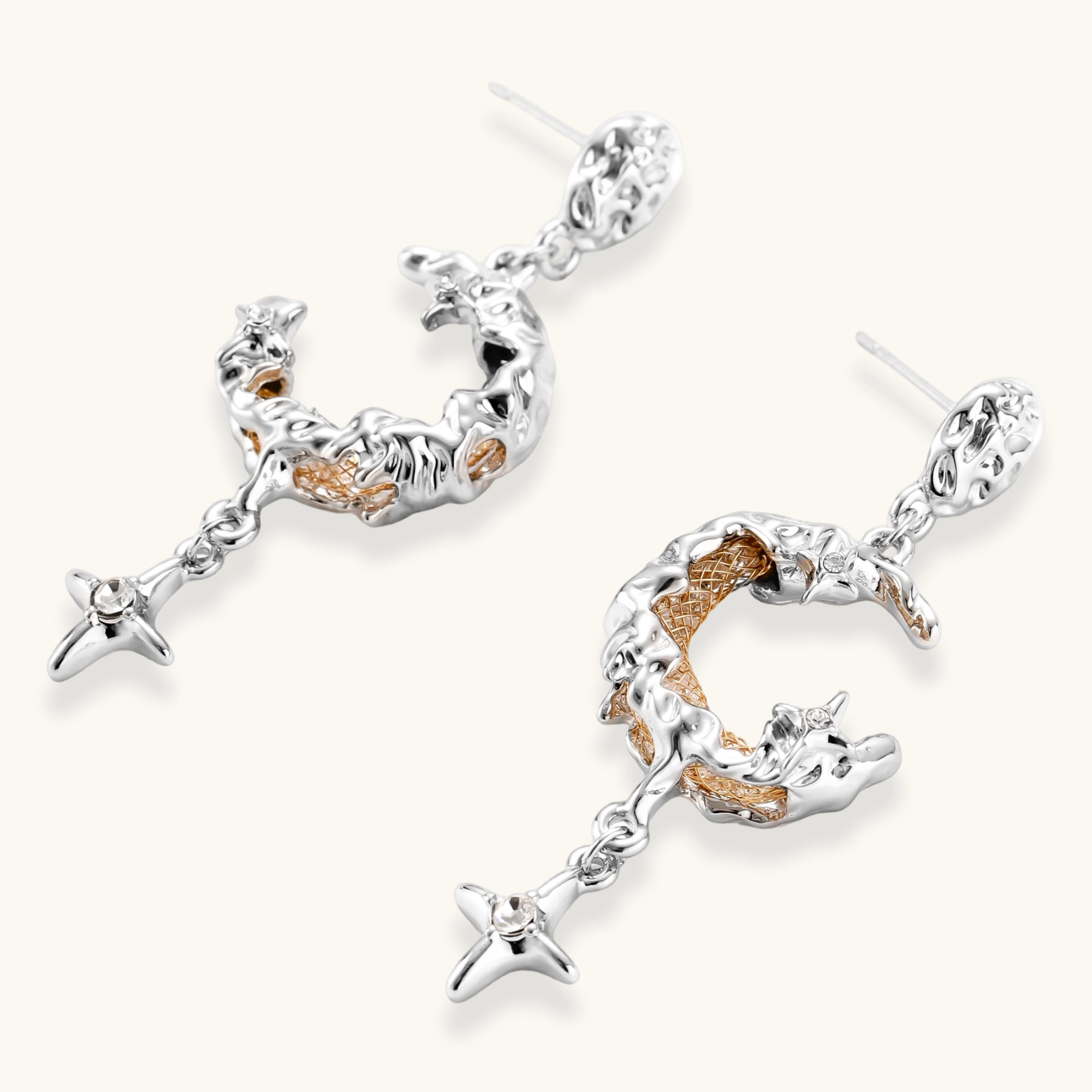 Detailed eco-brass dangle earrings featuring crescent moons with gold rope details and dangling star charms on white background.
