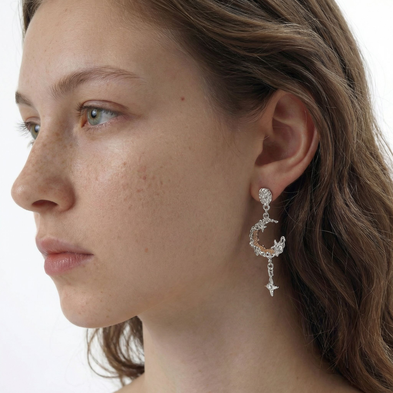 Detailed eco-brass dangle earrings featuring crescent moons with gold rope details and dangling star charms on white background.